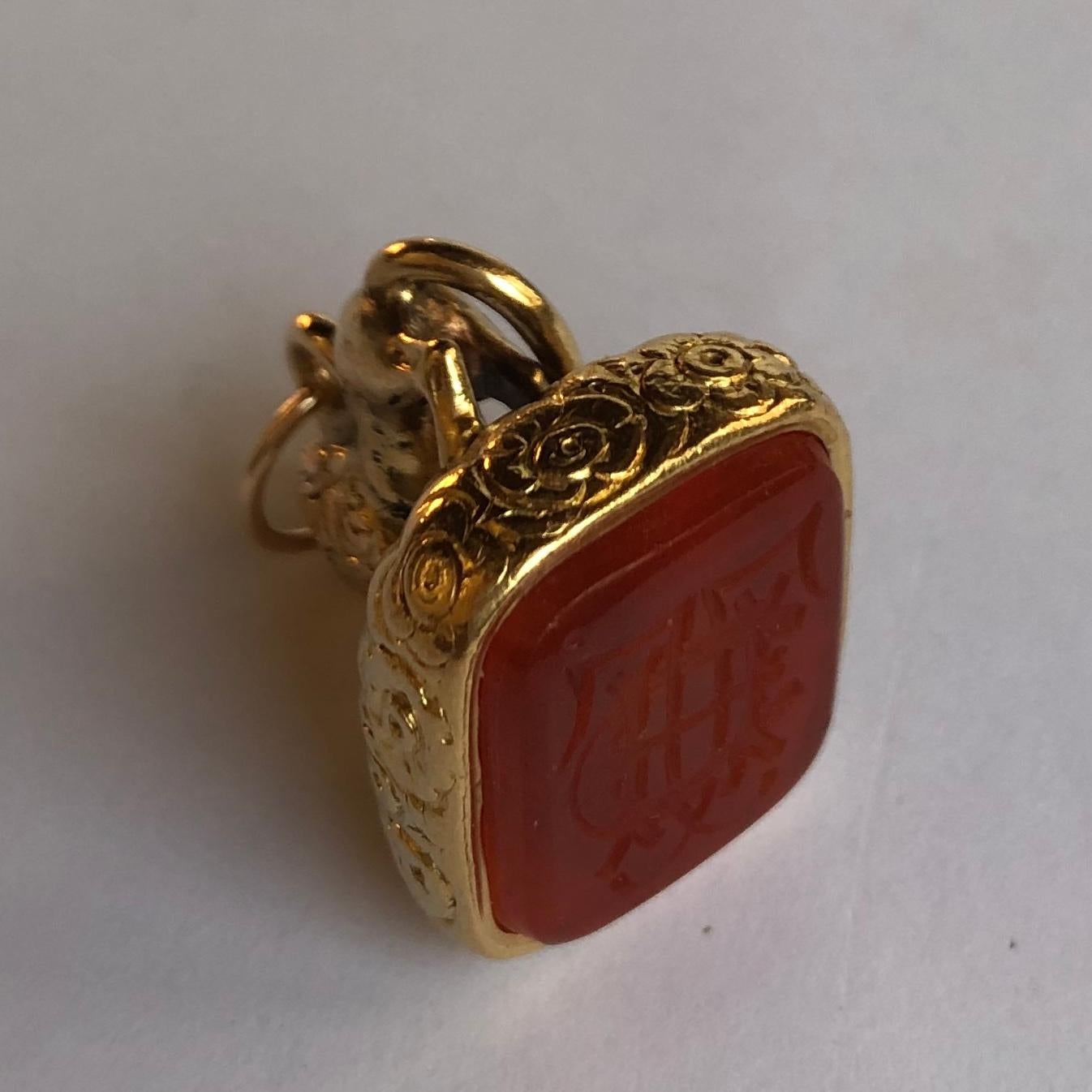 18Kt yellow gold lion seal with cornelian. 
The lion is symbol of power and strength.
The Brownish Orange cornelian, is rectangular cut with rounded corners (1.8cmx1.45cm). 
The cornelian is hand carved with the family initals and the horseshoe,