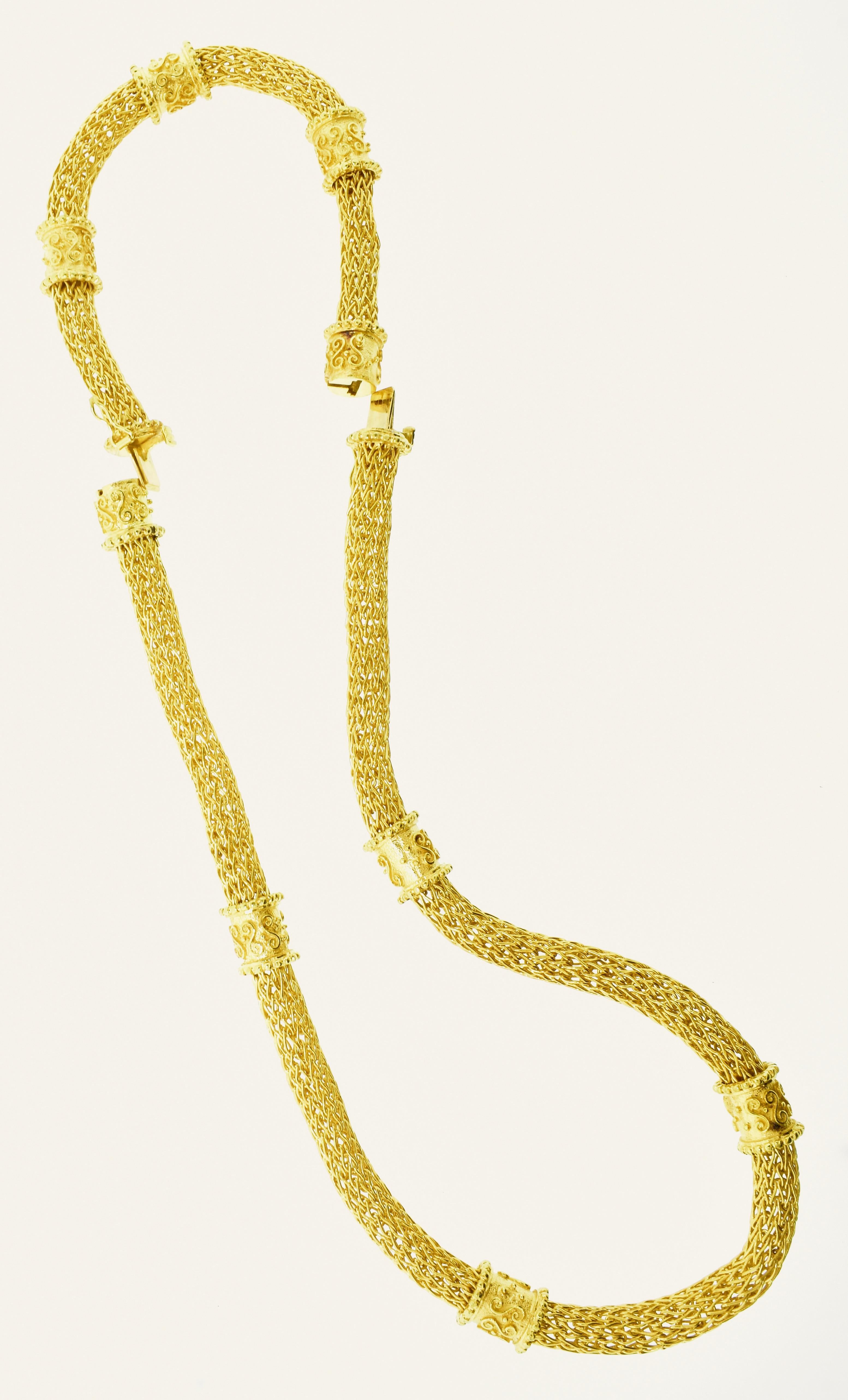 Important 18K yellow gold necklace and bracelet.  This is a 24.5 inch necklace that is one-half inch at its widest points.  It weighs 4.25 troy ounces or 132.25 grams. It consists of nine carved hard elements that fit over woven gold - which is