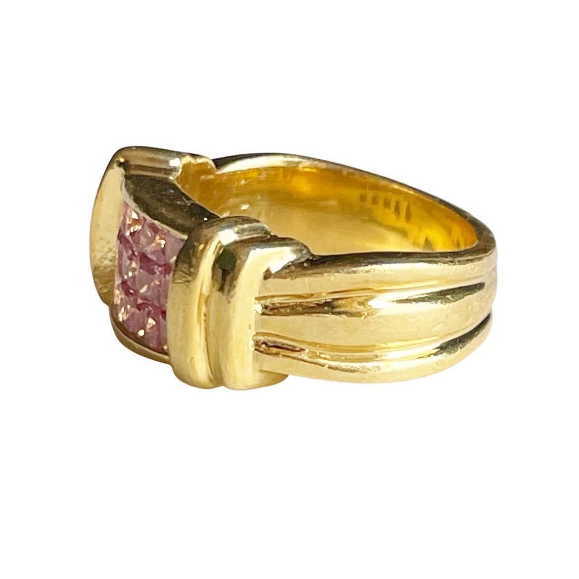 This unique gem is a beauty. Crafted in 18K yellow gold, the vibrant hue catches the eye without even trying. In the center of the column like design are princess cut pink sapphires that fit perfectly together like Toung and grove. Each facet of the