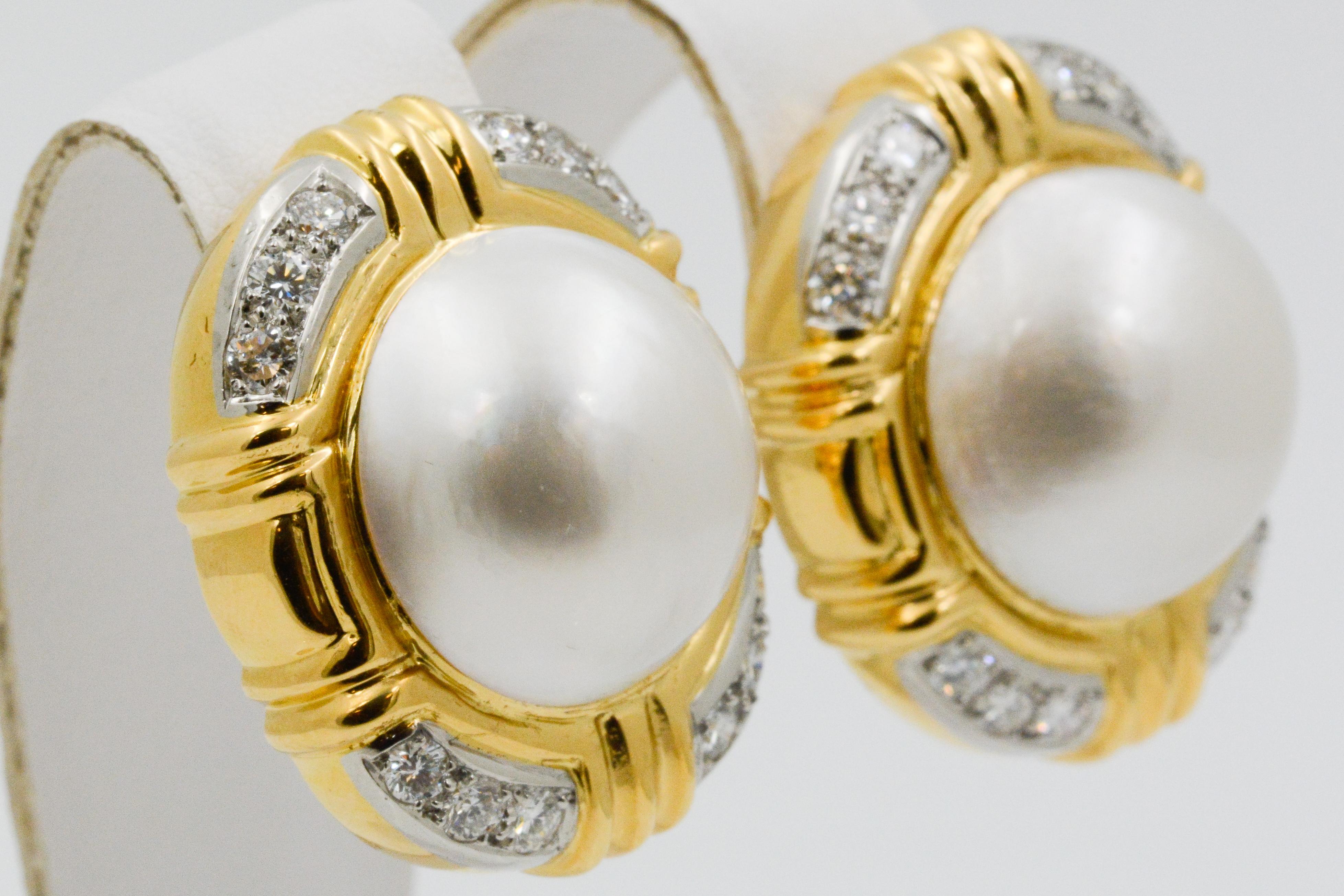 These large 18k yellow gold clip earrings feature two mabe pearls that measure 18.27mm in diameter and are accented with round diamonds that weigh a total of .75 carats. 