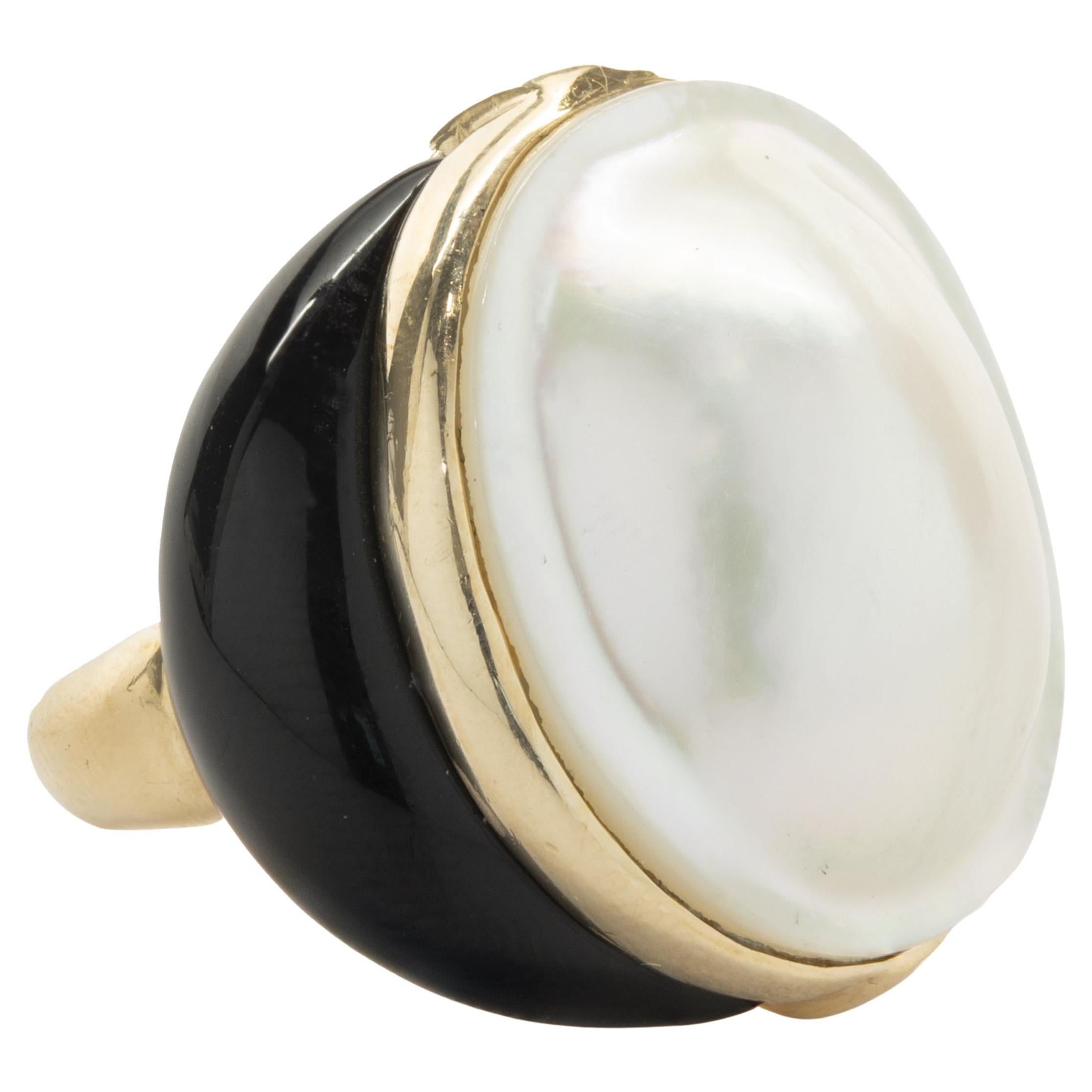 Designer: custom design
Material: 18k yellow gold
Mabe Pearl: 23 x 19.50mm
Ring Size: 6.25 (please allow two additional shipping days for sizing requests)
Dimensions: ring top measures 25.70mm
Weight: 18.22 grams
