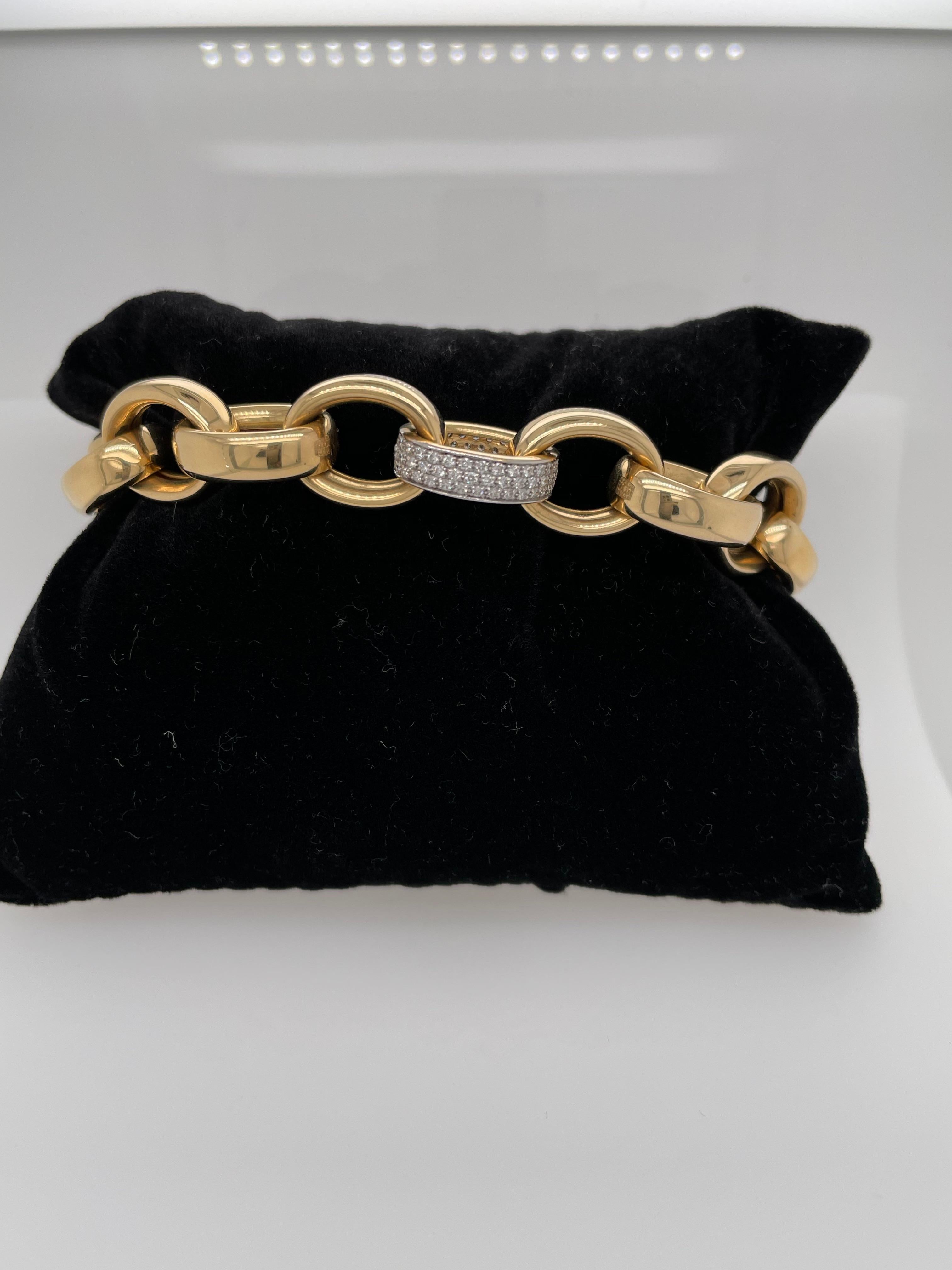 Gorgeous and super chic!  This Monica Rich Kosann is comprised of 18K yellow gold and diamonds.  The 18K Extra-large Ultra Bracelet has  a safety clasp on the catch and is adjoined with a diamond pave link.  The diamond carat weight totals .63 total