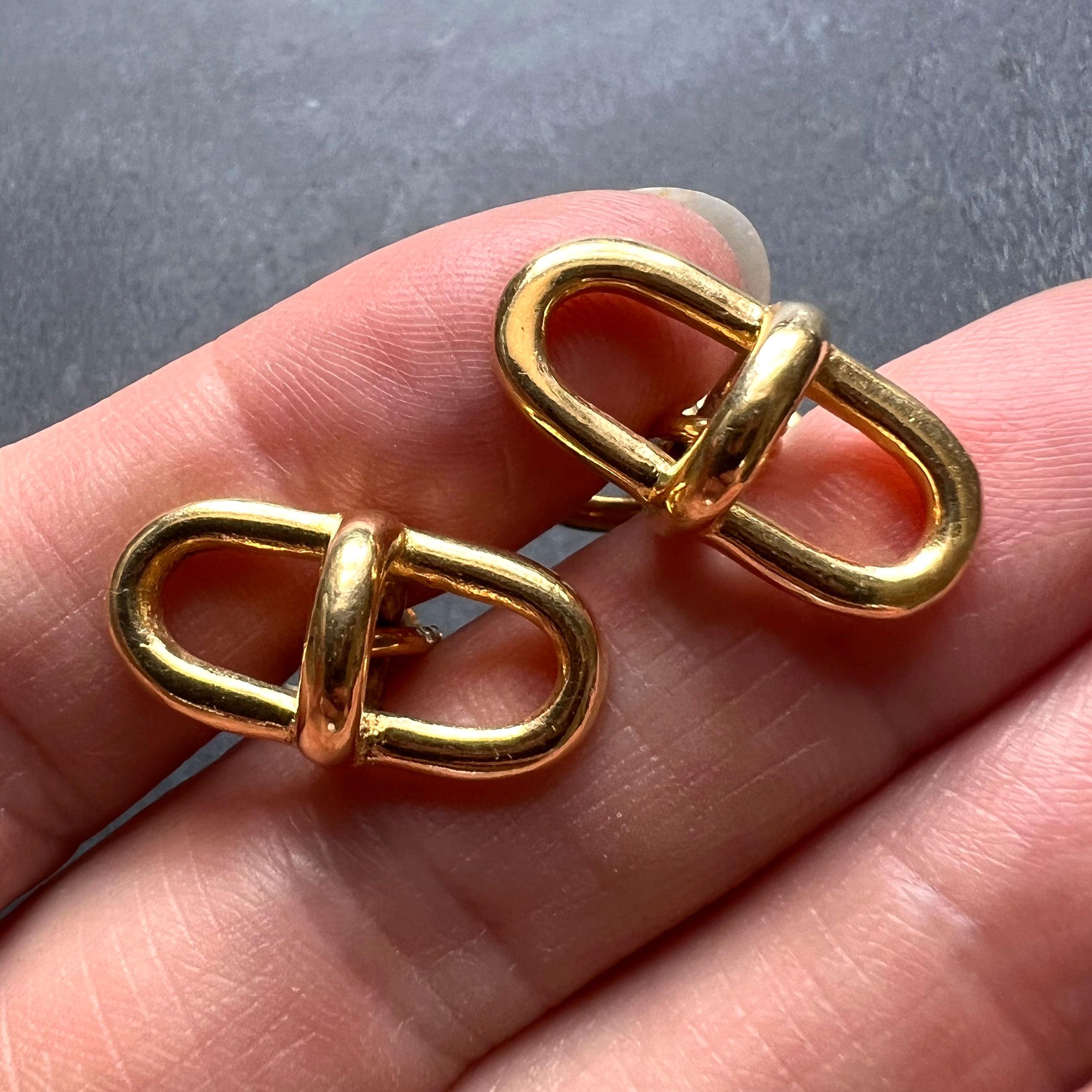 A pair of 18K (18 karat) yellow gold cufflinks each designed as a pair of links from a marine chain. Stamped with the owl for French import and 18 karat gold.

Dimensions: 2 x 1 x 2.4 cm 
Weight: 13.97 grams

