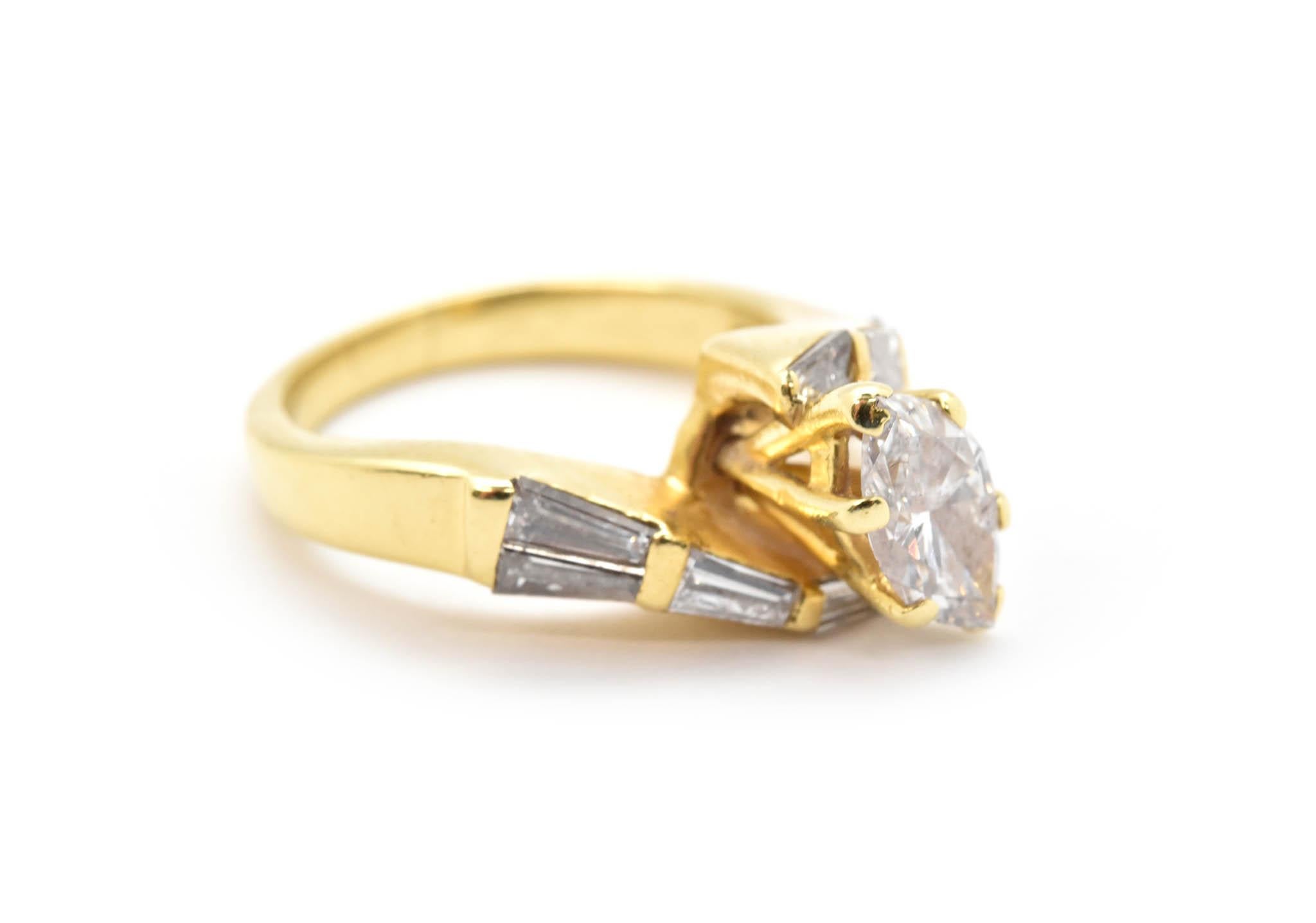 This lovely marquise diamond engagement ring is designed in 18k yellow gold, using a unique design with marquise and baguette diamonds. The center diamond of this ring is 0.85ct, H in color and SI2 in clarity. Surrounding the center stone, are