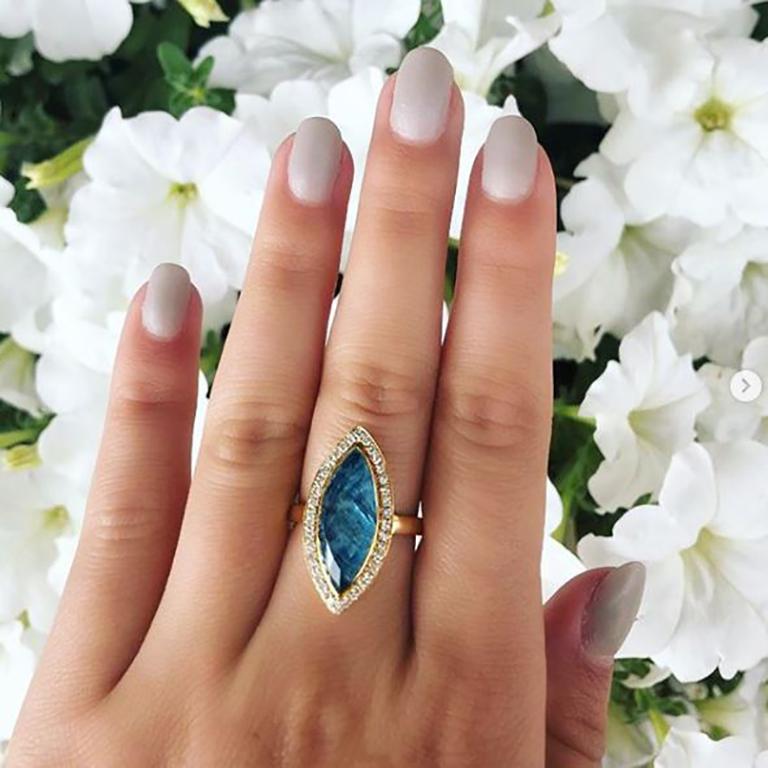 Laguna collection Cocktail Ring featuring an Marquise shaped doublet of stones: Apatite Base, topped with faceted Rock Crystal Quartz. Set in 18K Yellow Gold, with a Diamond Halo. Finger size 6.5, adjustable upon request/quote. The Laguna collection