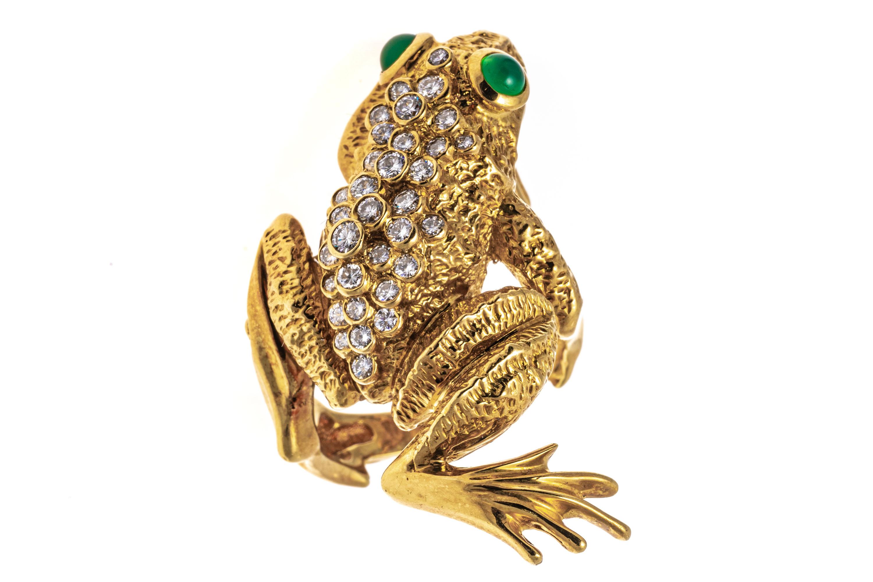 18k yellow gold ring. This beautiful ring is a figural frog, matte finished with high polished highlights, and set down the back with a cluster of bezel set, round brilliant cut diamonds, approximately 0.45 TCW.  Round cabachon cut green chalcedony