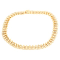 Collana a maglie e volute in oro giallo 18K