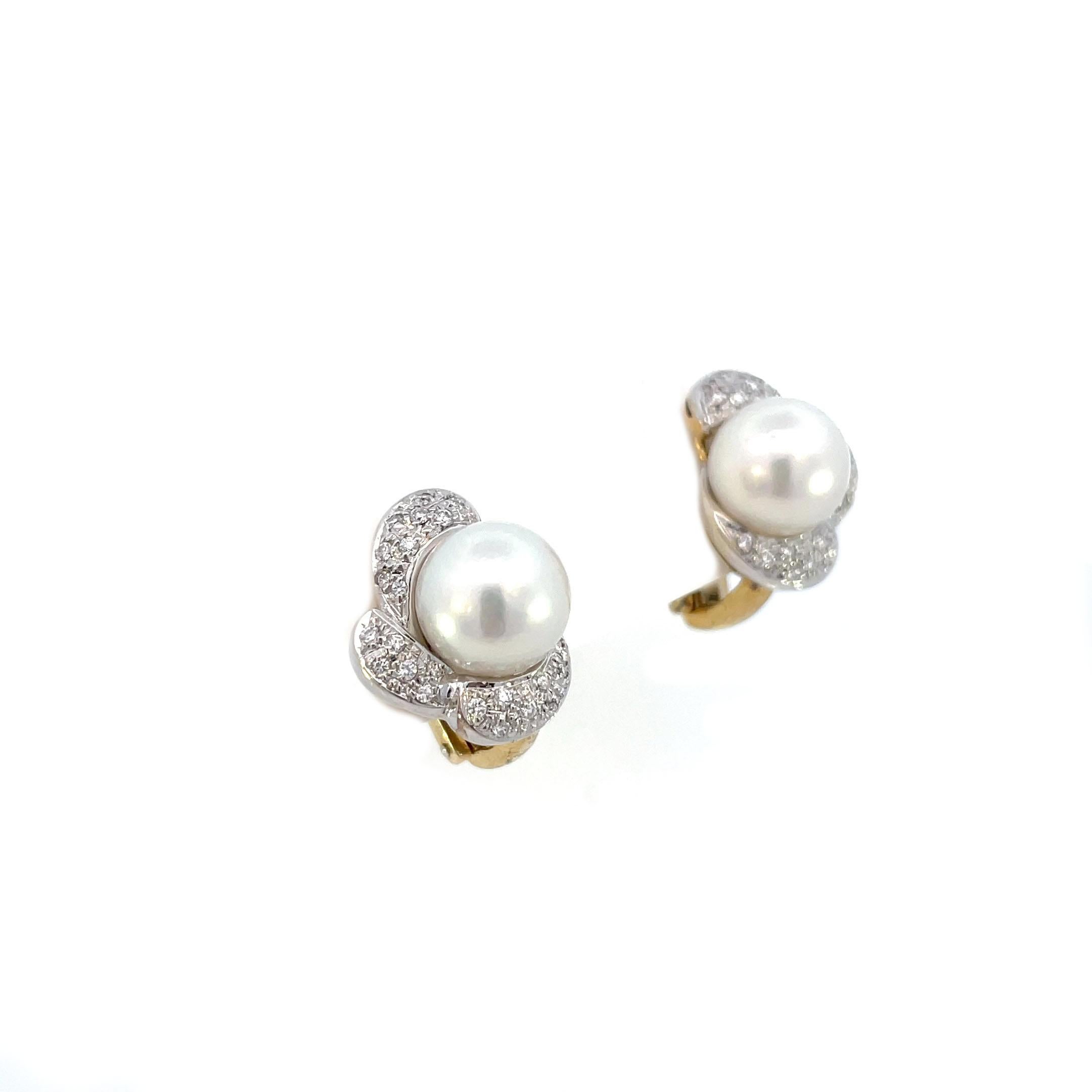 This is a absolutely stunning pair of lever back earrings crafted in bright and beaming 18K yellow gold, signed Mikawa, showcase a white pearl at the center and a sparkling diamond border. The craftmanship and design of these earrings is