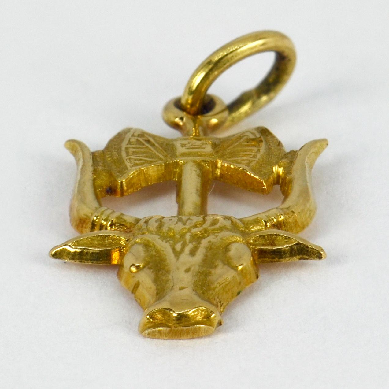 A 9 karat (9K) yellow gold charm pendant designed as the Minoan symbols of the bull and double headed axe (the Labrys). Stamped 750 for 18 karat gold and numbered A68. 

Dimensions: 2 x 1.2 x 0.15 cm (not including jump ring)
Weight: 1.64 grams
