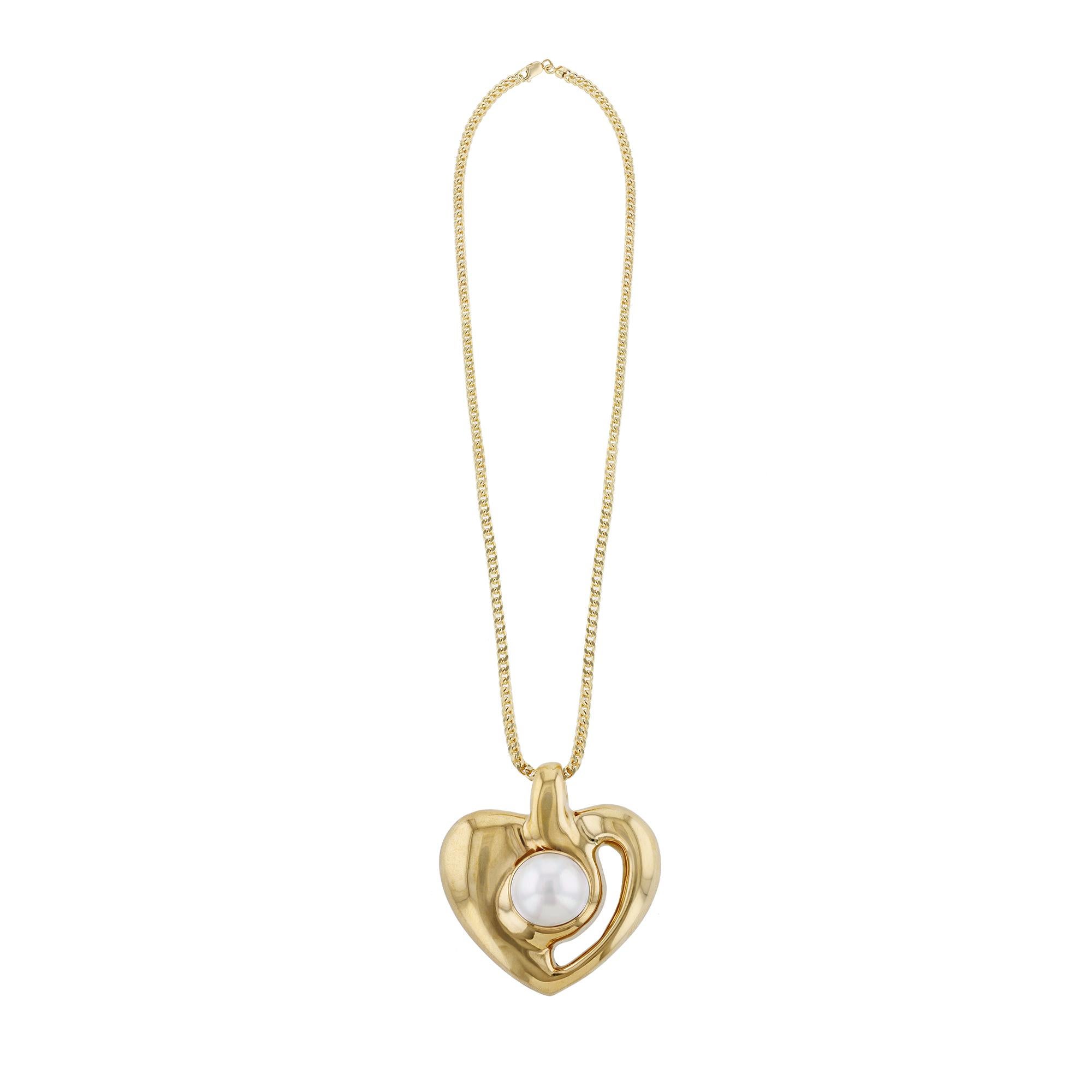 This necklace features an 18K Yellow Gold heart pendant with a Mobe Pearl. On a 14K Yellow Gold chain.