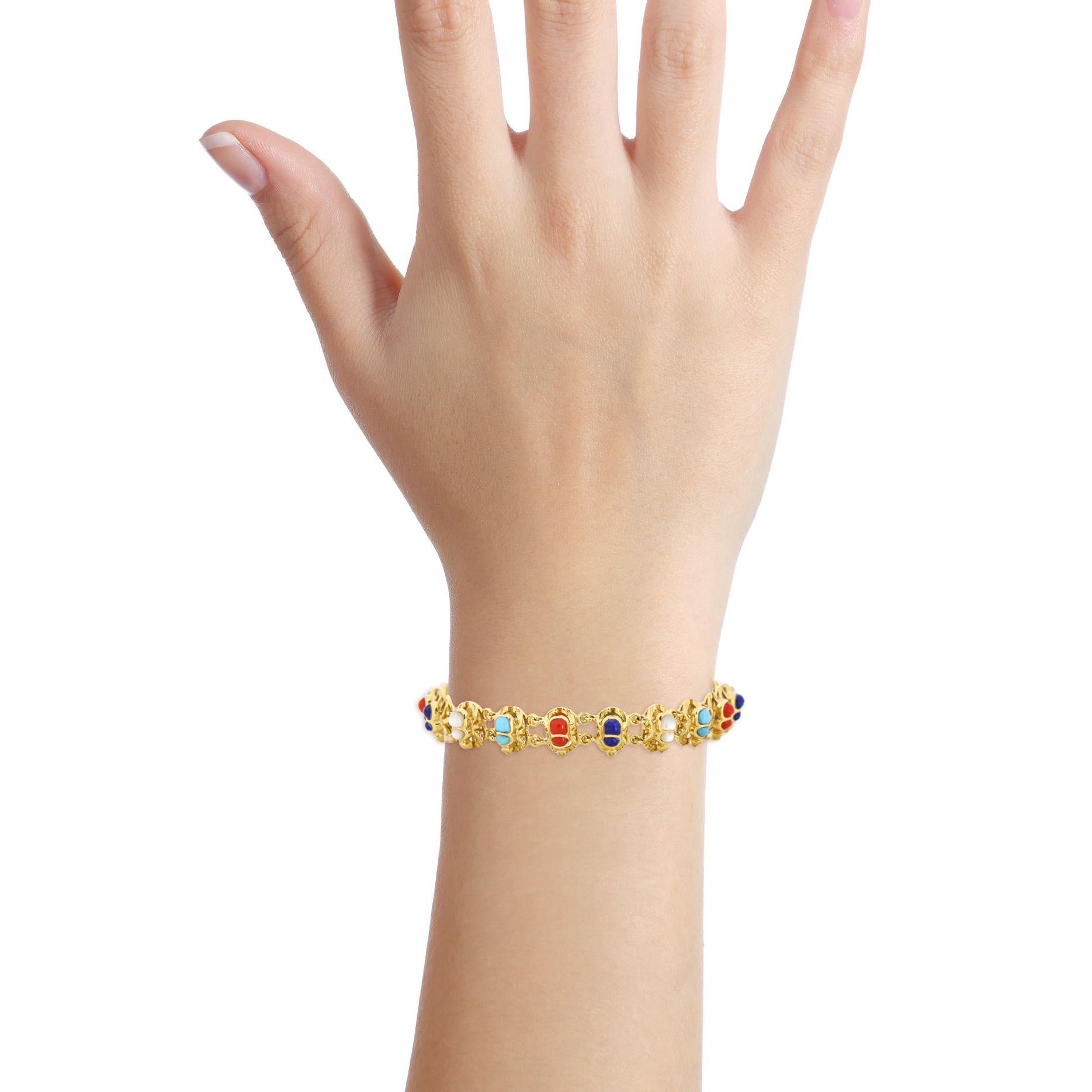 Scarab link bracelet in 18-karat yellow gold with gemstones. Slide clasp. 

Size, 7.25 inches
Width, 10mm
Depth, 6mm
Weight, 24.8 grams 

Previously owned, in excellent condition. Original packaging not included. Cleaned and polished. All pictures