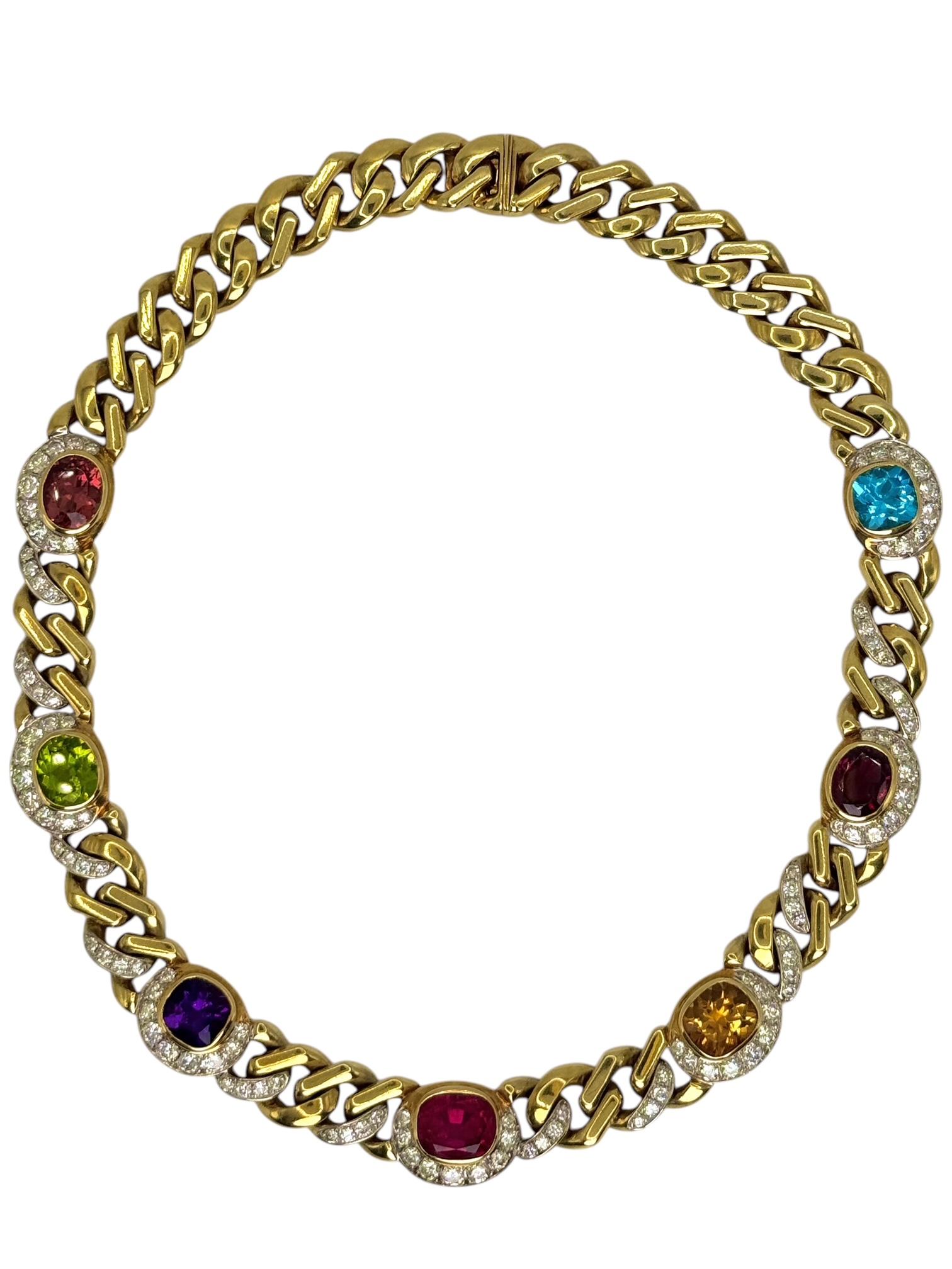 A stunning vintage statement necklace signed FURST, crafted in rich 18k yellow gold (stamped 750). This vibrant piece features a dazzling mix of gemstones, including a 4.36 carat pink tourmaline, a 4.05 carat amethyst, a 5 carat topaz, a 4 carat