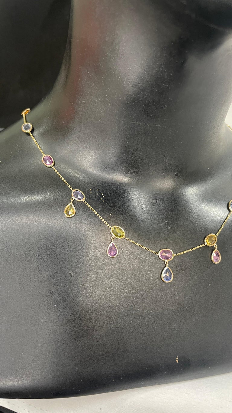 Multi Sapphire Necklace in 18K Gold studded with oval, pear cut sapphire pieces.
Accessorize your look with this elegant multi sapphire beaded and drop necklace. This stunning piece of jewelry instantly elevates a casual look or dressy outfit.