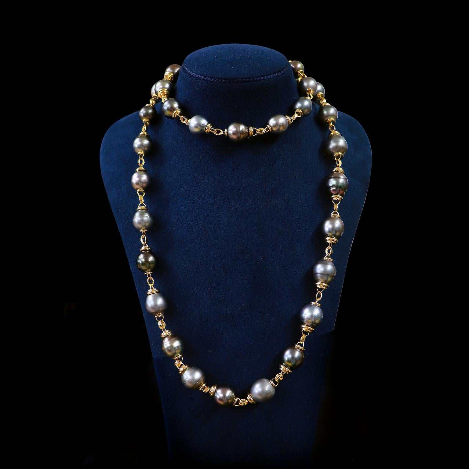Treasured Tahitian pearls are gathered with lustrous 18k yellow gold for this necklace. Pearls with silver and green overtones exude their signature prismatic shimmer. Each pearl is topped with an 18k yellow gold double-ribbed cap and features a
