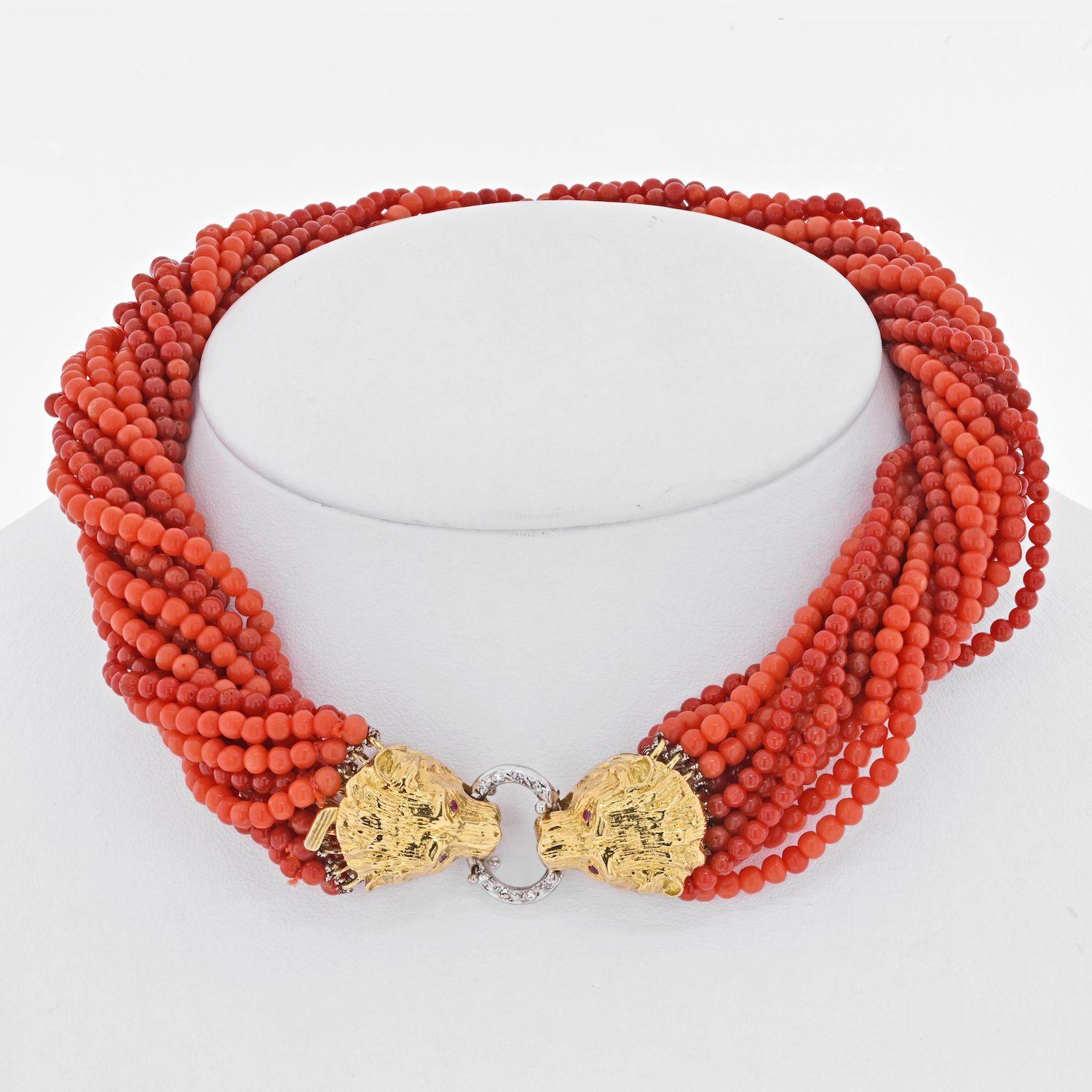 Beautiful multi-strand coral bead trosade necklace made with round bead bright salmon color corald strands finished with 18k gold clasp fashioned as two bear heads latching on a ring. The ring is of white gold and is accented with a few round cut