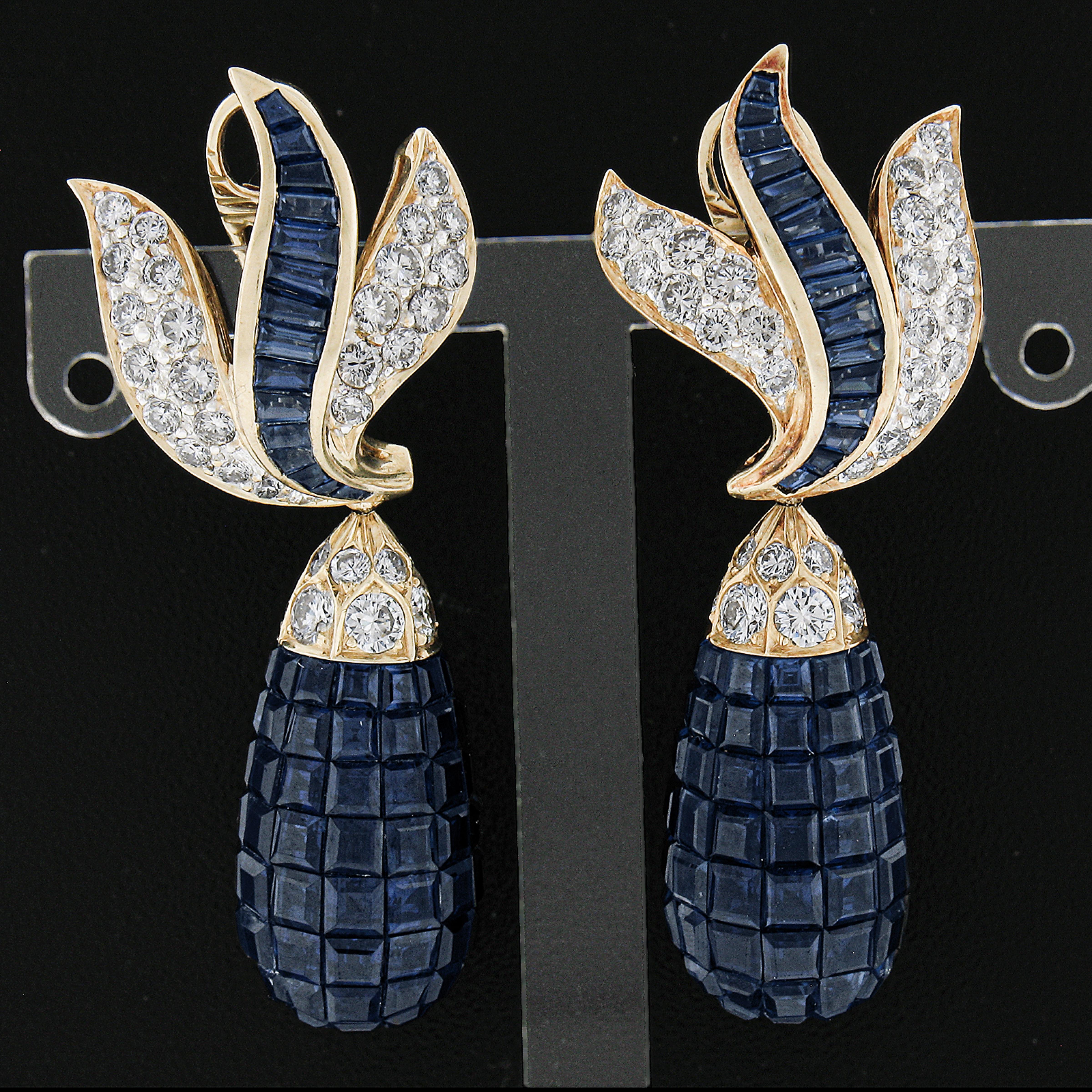 These magnificent dangle Day/Night earrings feature flame style tops with channel baguette sapphires and fiery pave diamonds. The optional drops are 3D tear drops covered in calibre cut invisible set sapphires - one of the most difficult feats in