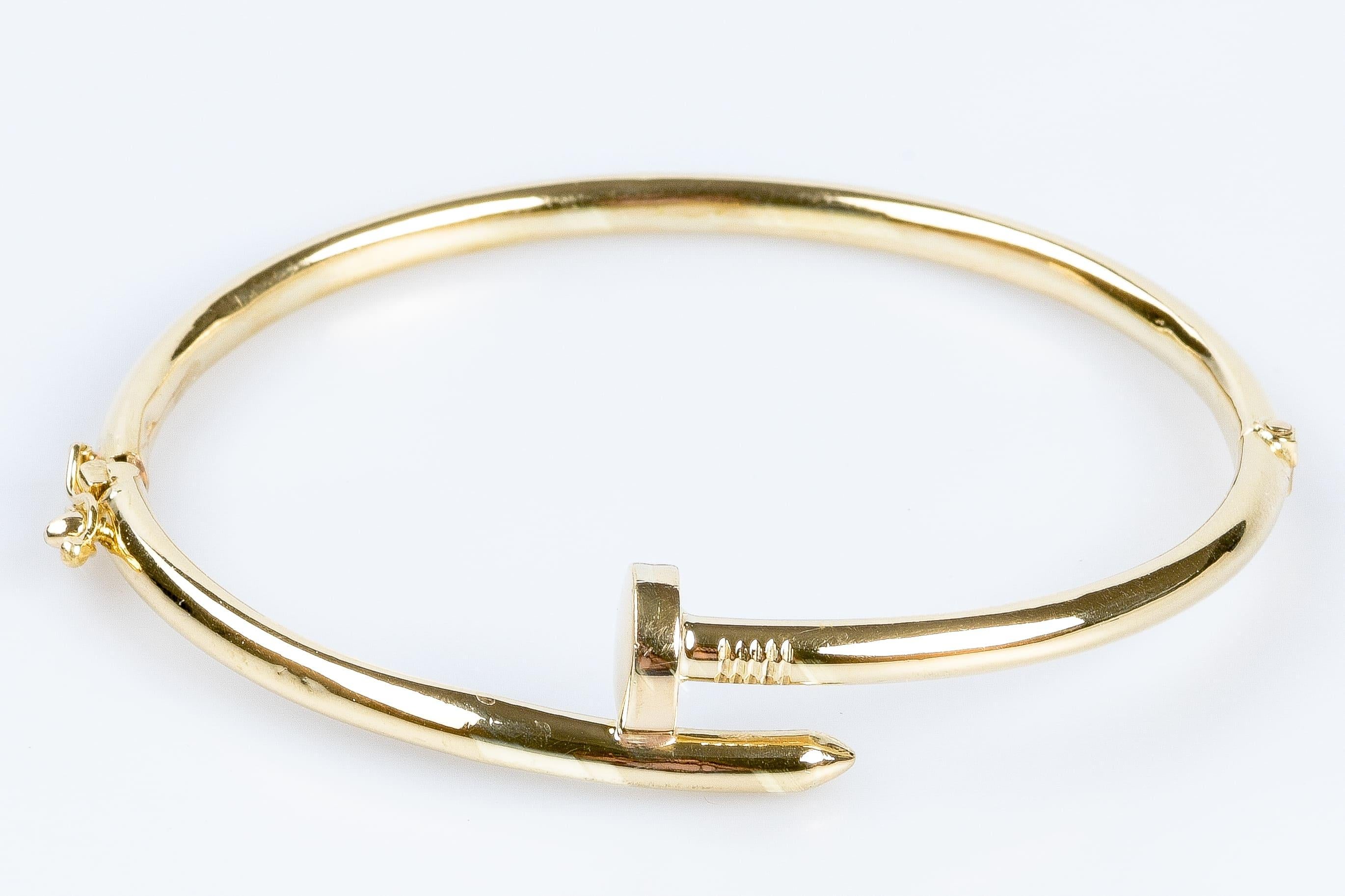 18K Yellow Gold Nail-Shaped Bracelet. This bracelet has a curved shape that fits the wrist and a clasp that allows you to put it on and remove it very easily while guaranteeing a safe and comfortable fit. The nail shape is elegant and fashionable