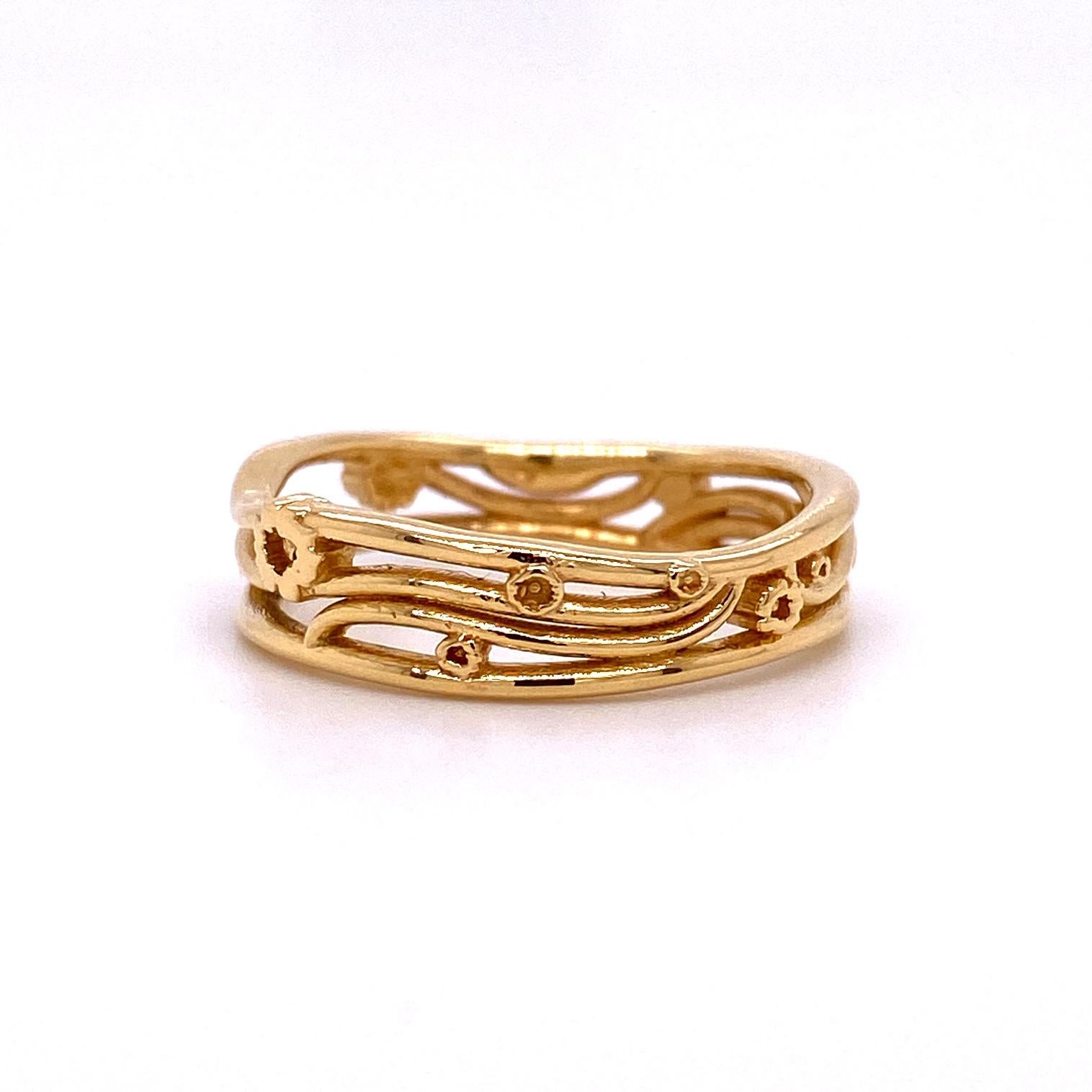 An 18k yellow gold Gustav Klimt inspired narrow band. Ring size 7. This ring was made and designed by llyn Strong.