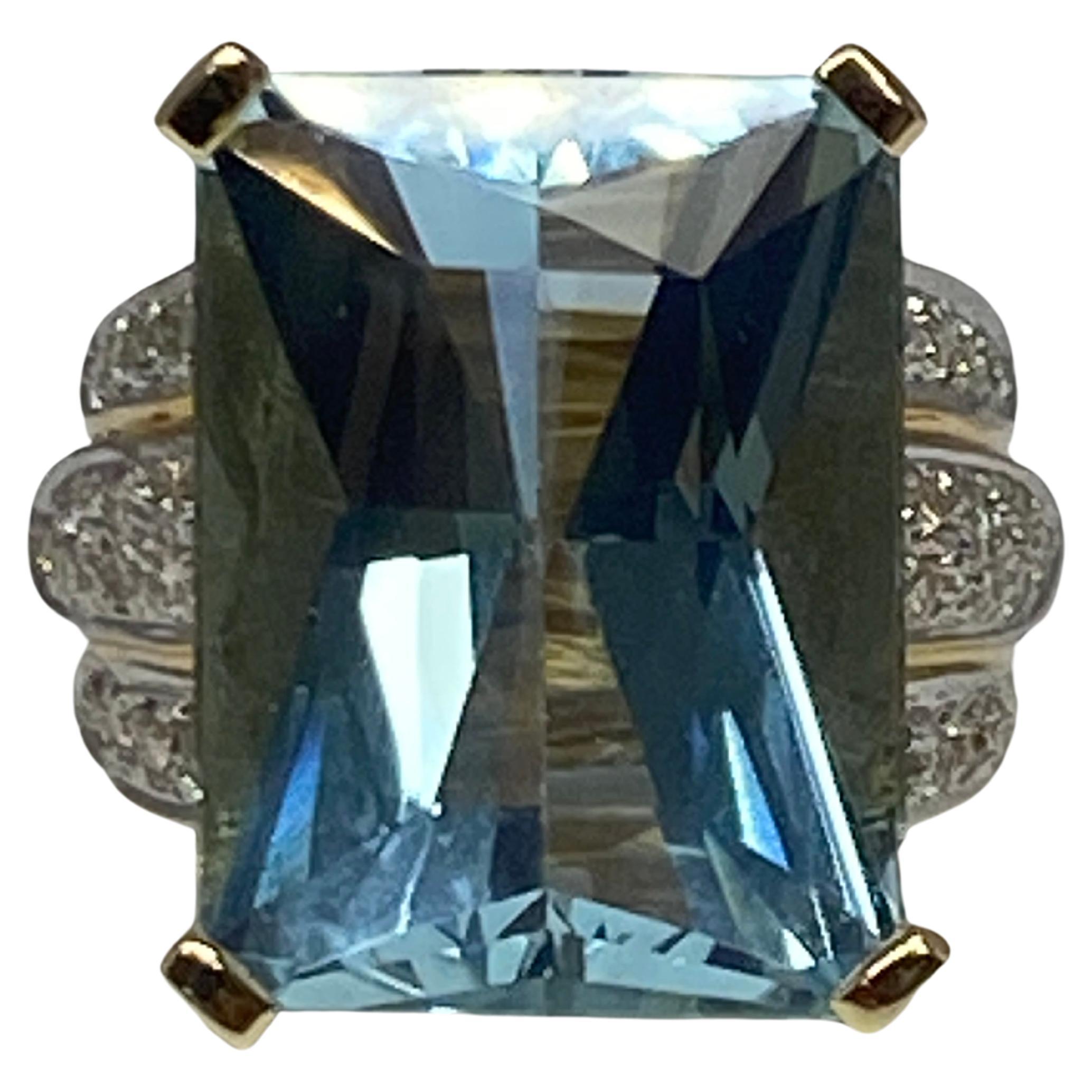 This aquamarine cocktail ring is a fabulous statement piece, At the center sits a large natural 21 carat serene blue aquamarine with a fantastic sparkling and unusual mixed cut design. The substantial chunky setting catches the eye with it's