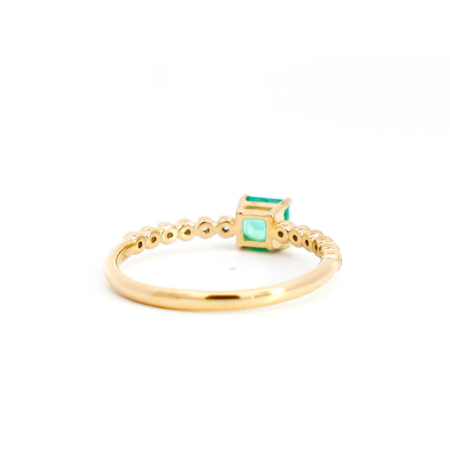 Natural Green Emerald and Natural Diamond Stacking Ring, Set in 18K Yellow Gold. Set with eye-clean white diamonds and a vivid green emerald of Colombian origin. Fixed with a 4-prong and bezel setting that features a stunning ribbed band. Ideal for