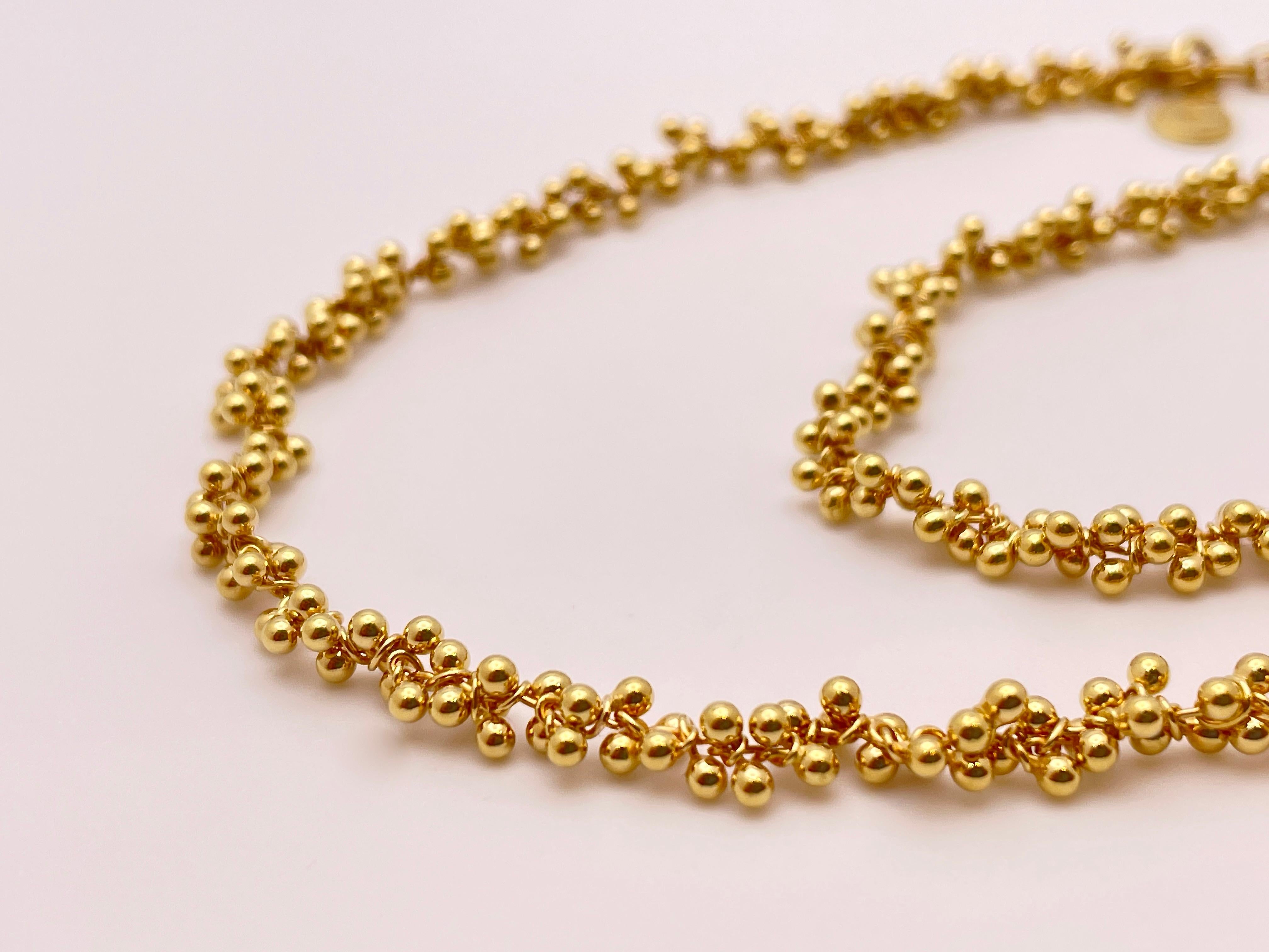 An extraordinary 18K yellow gold signed designer flexible necklace/choker measuring 15 inches and weighing 28.80 grams. 