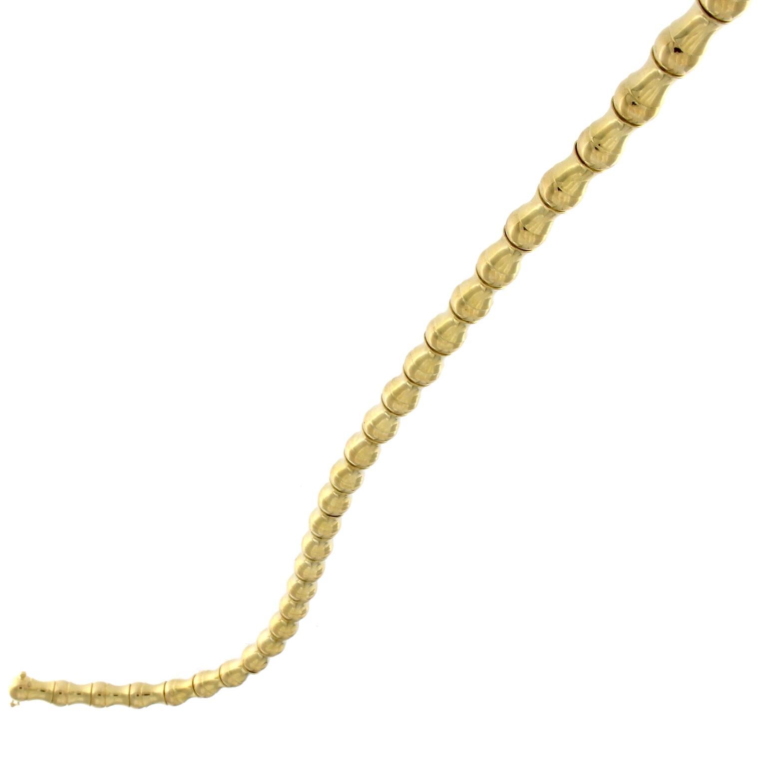 18k yellow gold necklace, a sequence of beads and curvy elements slip on a chain
the gold Weight  is GR 68.9

Stamp 10 MI 750

