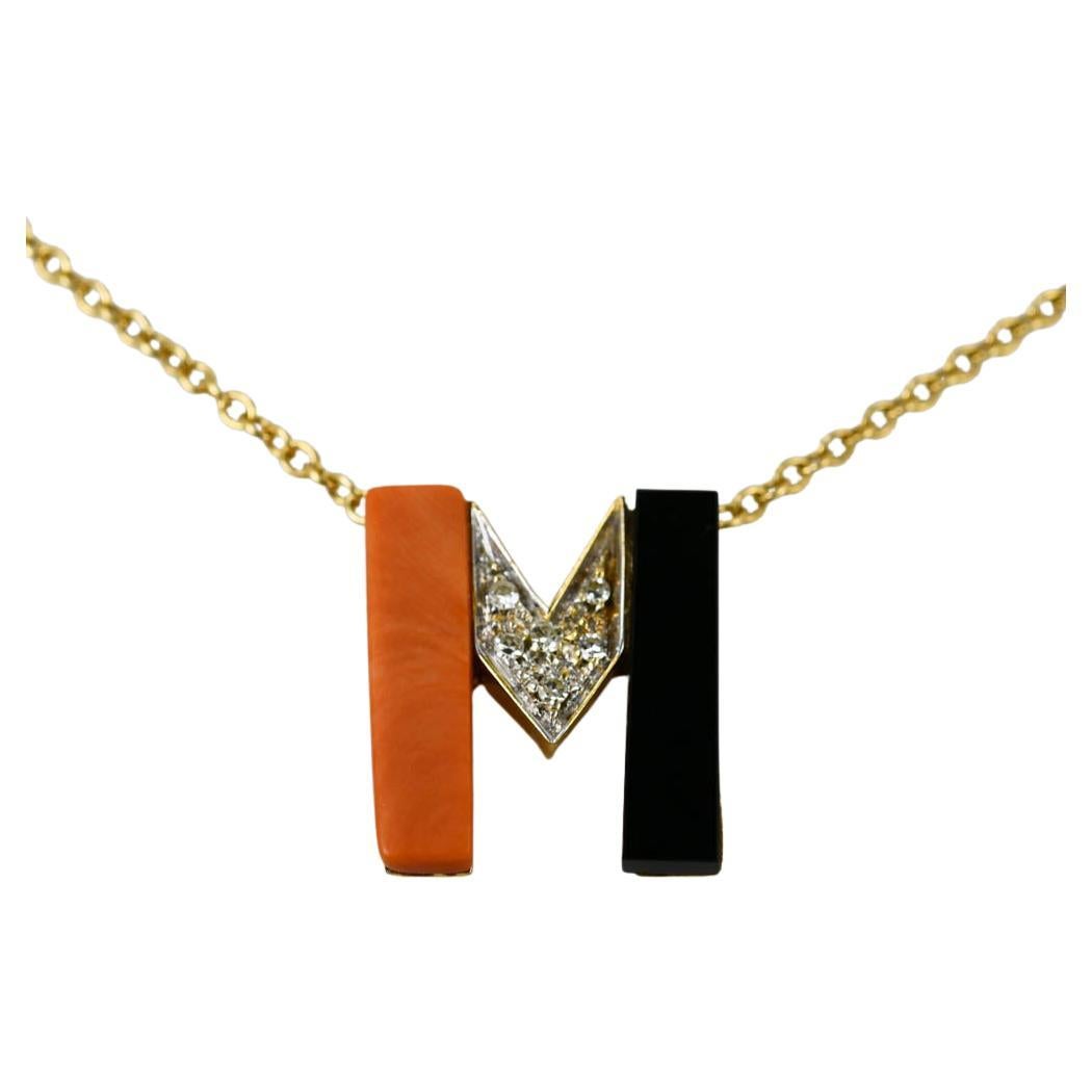 18k yellow gold necklace with pink coral, black onyx and diamond pendant.
Stamped 18k and weighs 8.1 grams.
The diamonds are single cuts, .10tdw, H to i color, Vs to Si clarity.
The chain measures 16 inches long.
Very good condition.