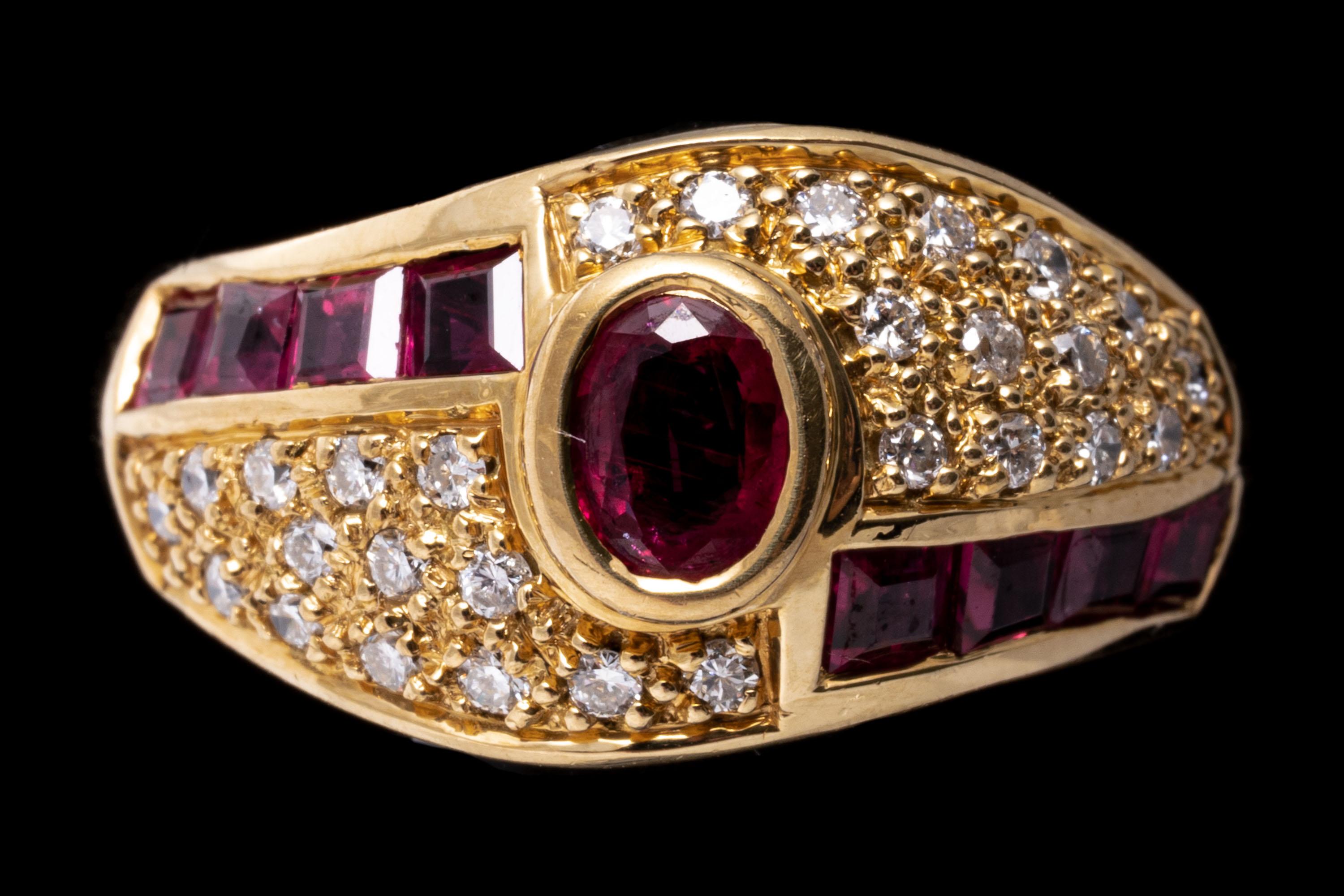 18k yellow gold ring. This gorgeous yellow gold dome ring is set with a center faceted oval, reddish pink color ruby, approximately 0.18 CTS, bezel set. The center is flanked by offset fields of pave set, round faceted diamonds, approximately 0.14