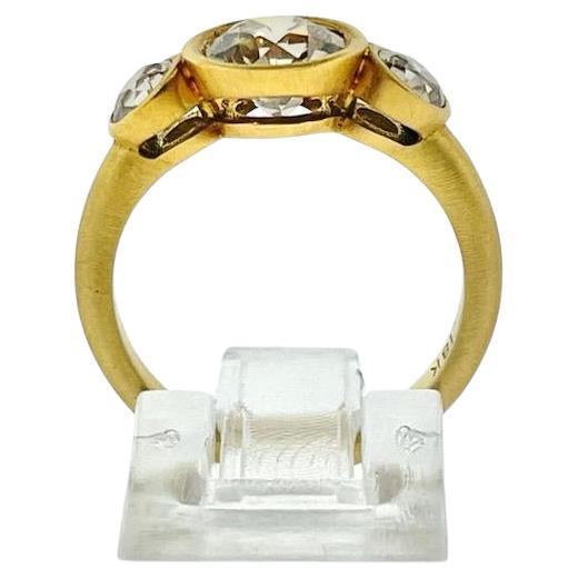 Make a statement with this vintage style three stone old european diamond ring. It is set in 18 Karat Yellow Gold with one (1) old european cut round diamond center weighing 1.59cts and two (2) old european cut round diamond sides weighing 0.70ctw.
