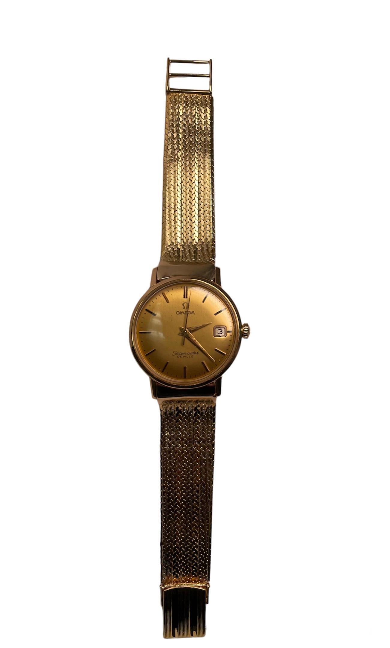 This is an 18k yellow gold Omega Men Watch. It is a Seamaster De Ville model. It is known as an elegant dress watch. It has a manual winding movement. The dial is champagne color and is hallmarked Omega with its logo at the top and Seamaster De