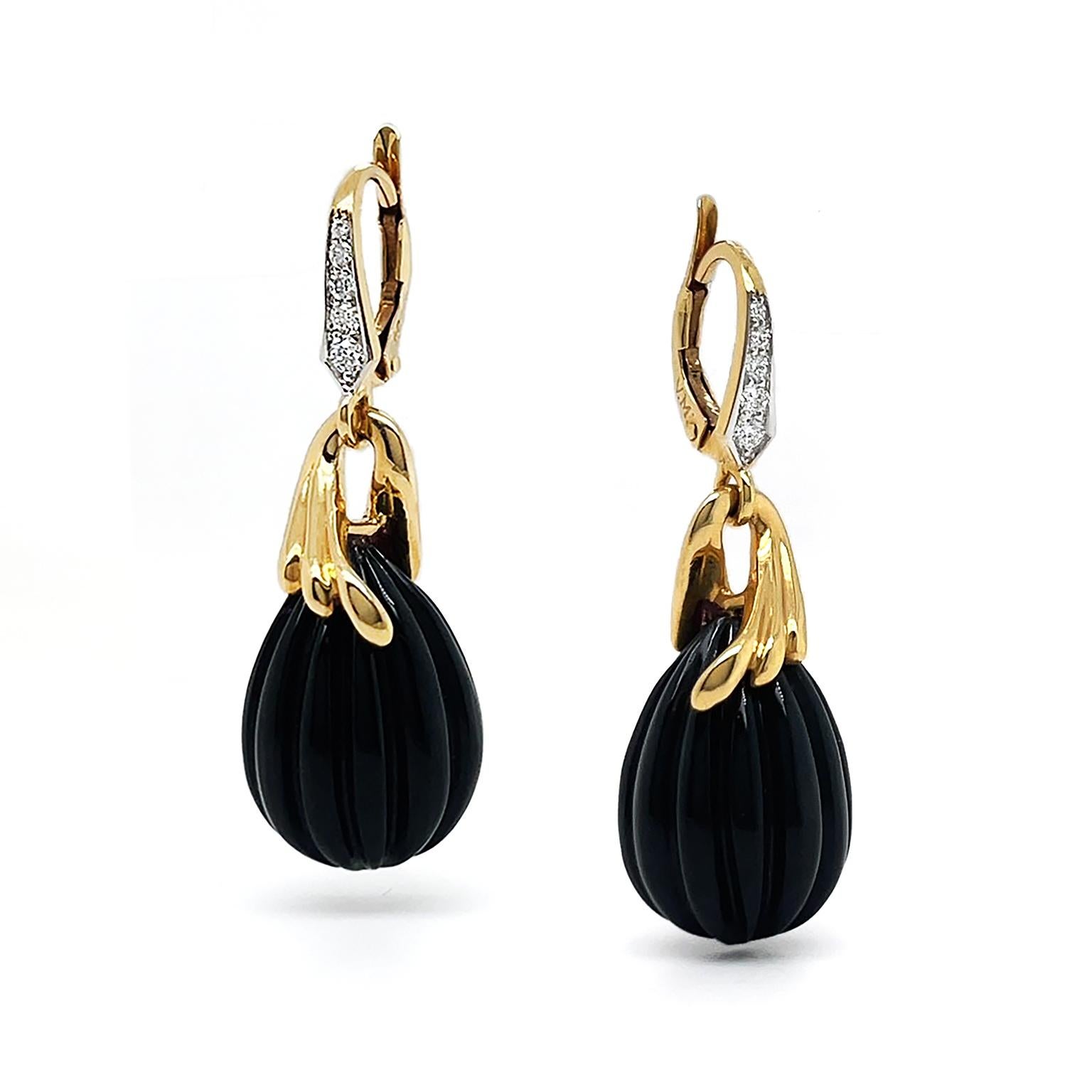 Diamonds and gold combine with onyx for a refined rendition of drop earrings. 18k yellow gold lever backs are set with an ascending row of brilliant cut diamonds. They are connected to a three-grooved gold loop, forming a cap over a teardrop carved