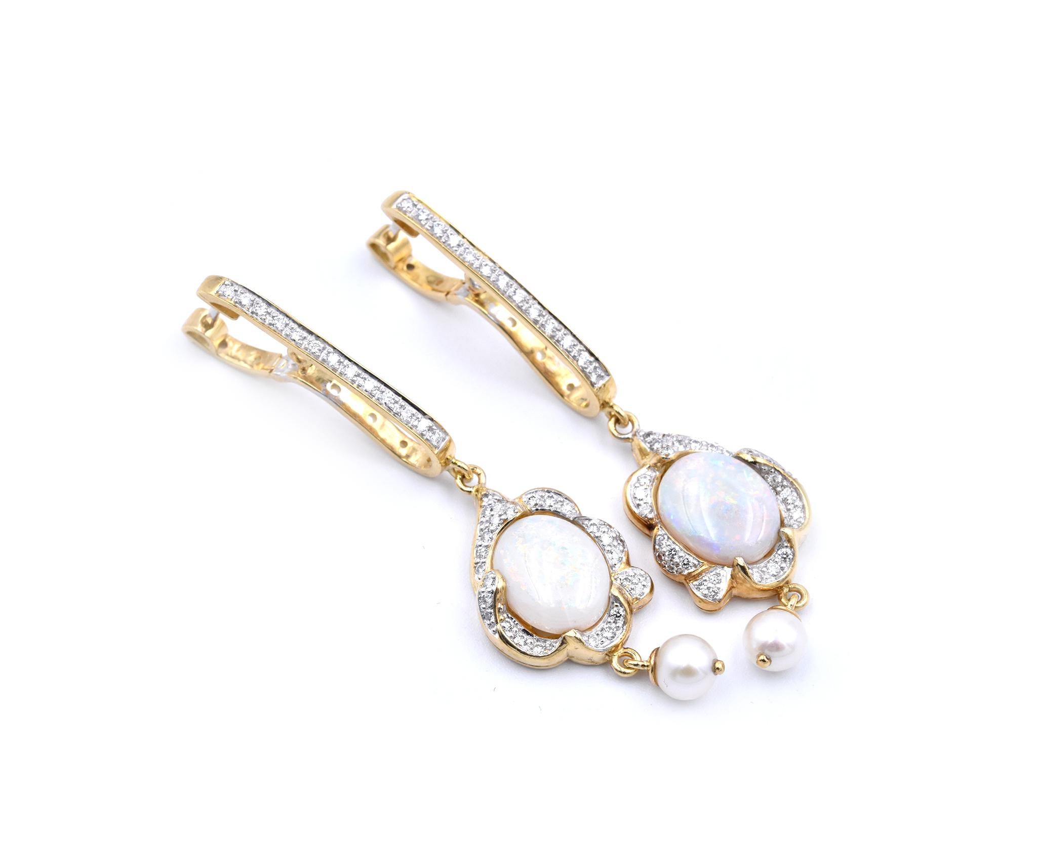Designer: Customs
Material: 18k yellow gold
Opal: 2 oval cut opals
Diamonds: 54 round brilliant cuts = 0.54cttw
Dimensions: earrings measure 13.80mm x 56.55mm
Fastenings: snap closure
Weight: 13.46 grams