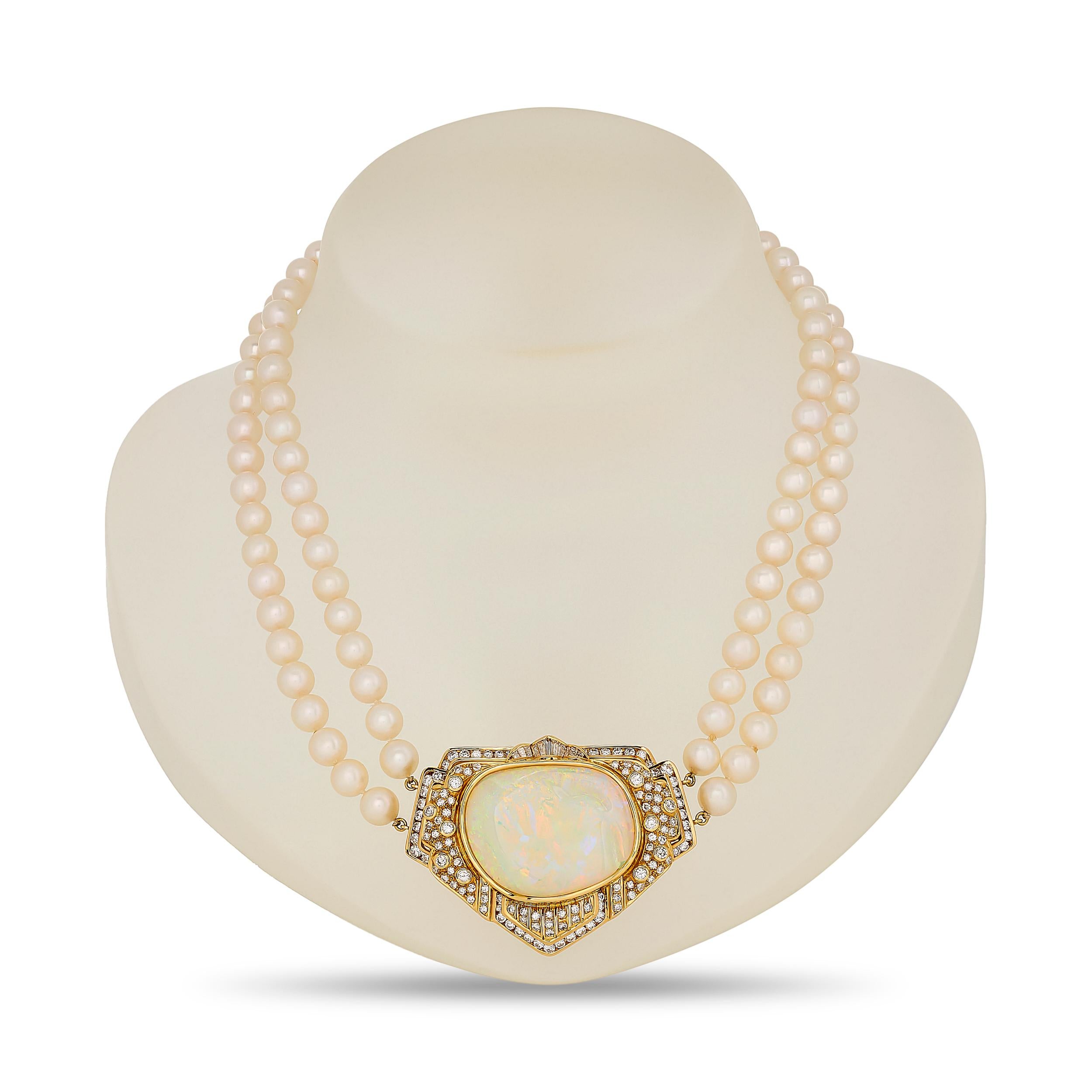This necklace features two strands of pearls centered by an oval-shaped opal in a diamond-set 18 karat yellow gold frame.

There are 103 pearls that measure ~7.5mm to ~7.9mm.
There is approximately 3.30 total carats of diamonds, they are G-H color
