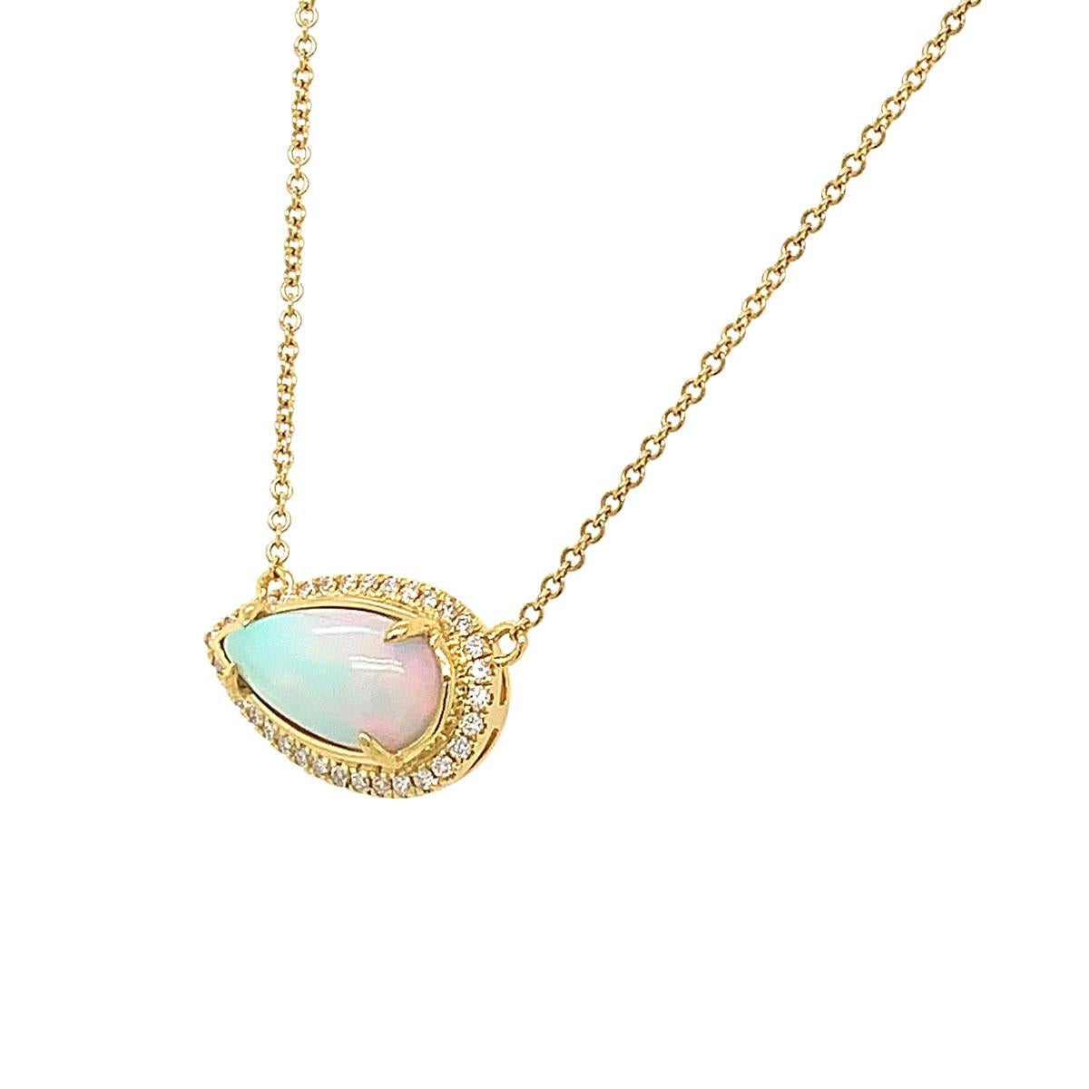 This colorful opal and diamonds Necklace features a Pear Shape opal framed by a halo Micro prong round brilliant diamonds. 4 diamonds are bezel set along the chain in 18k yellow gold. Experience the Difference !

Product details: 

Center Gemstone