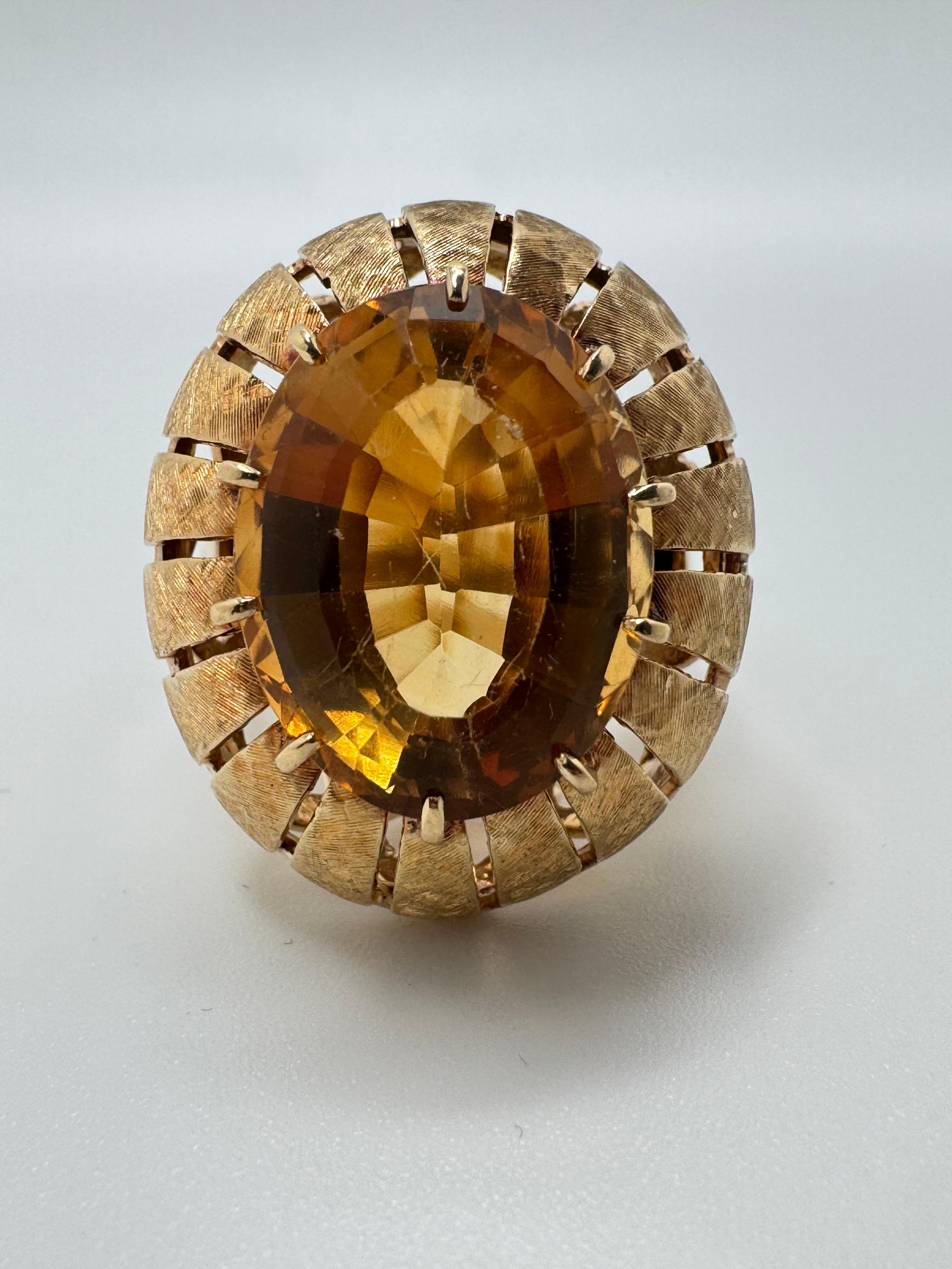 Crafted in rich 18K yellow gold, this striking ring features an elongated oval-cut citrine measuring approximately 16x12mm and displaying a warm, golden hue. The gemstone is securely prong-set, allowing excellent light flow to enhance its brilliance