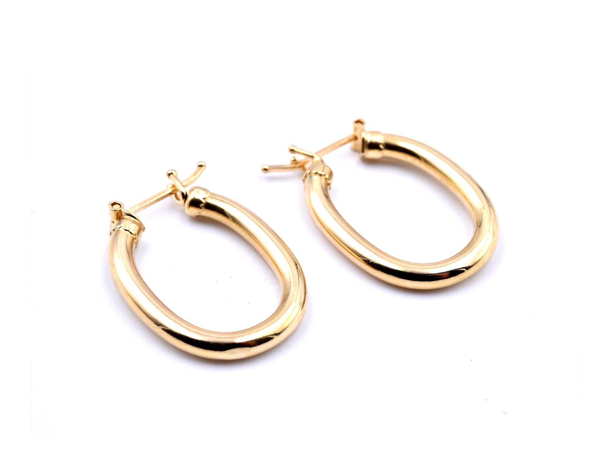 Designer: custom design
Material: 18k yellow gold
Dimensions: earring measures 24.81mm by 3mm
Fastenings: saddle backs
Weight: 3.10 grams
