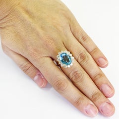 Vintage Oval Aquamarine and Diamond Halo Cocktail Ring in 18 Karat Yellow Gold