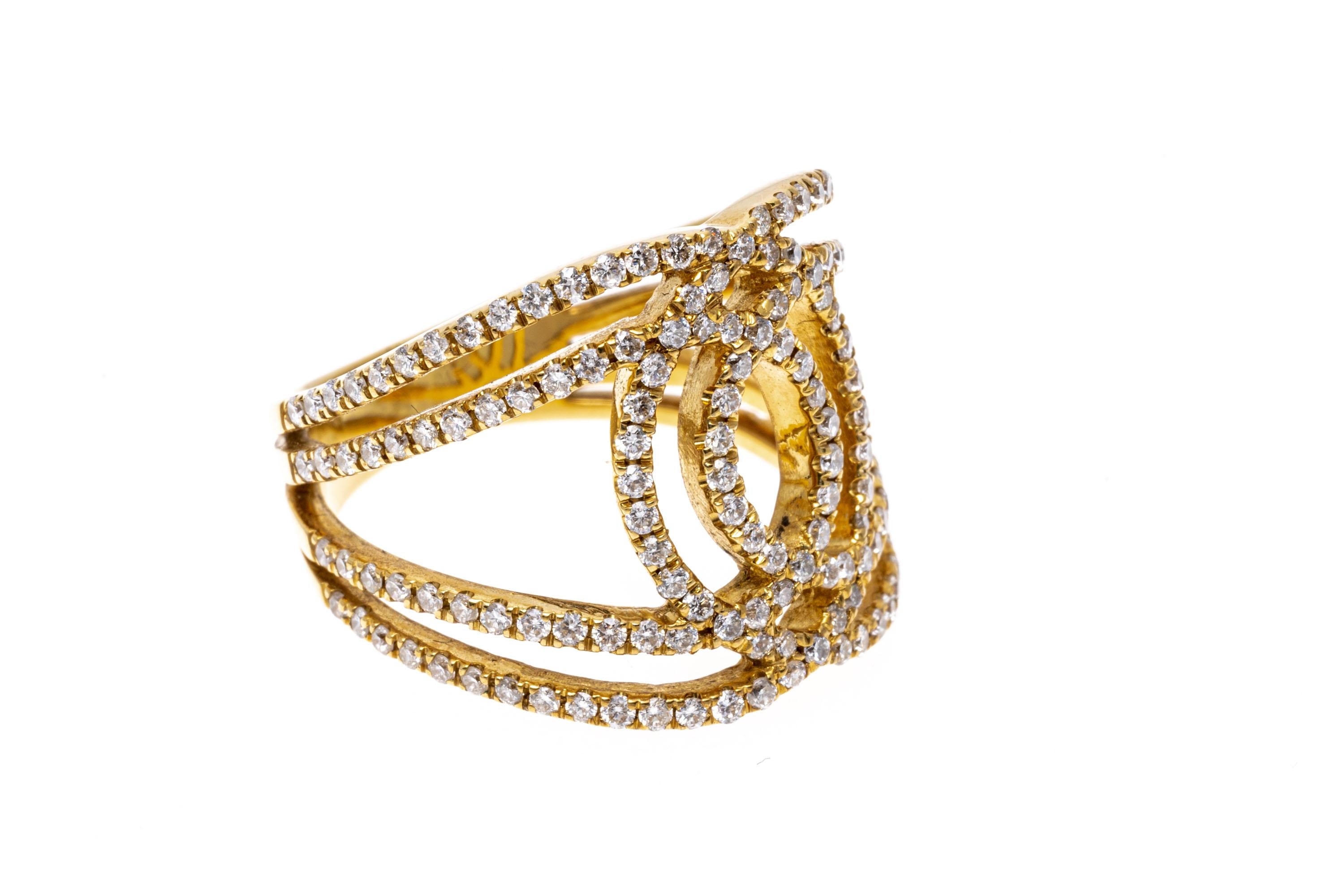 A super chic 18K yellow gold ring. Interwoven and over lapping trails of diamonds create an eye-catching and brilliant display. The diamonds are approximately 1.2 TCW. Ring size 7.5.
Marks: 18K
Dimensions: 11/16