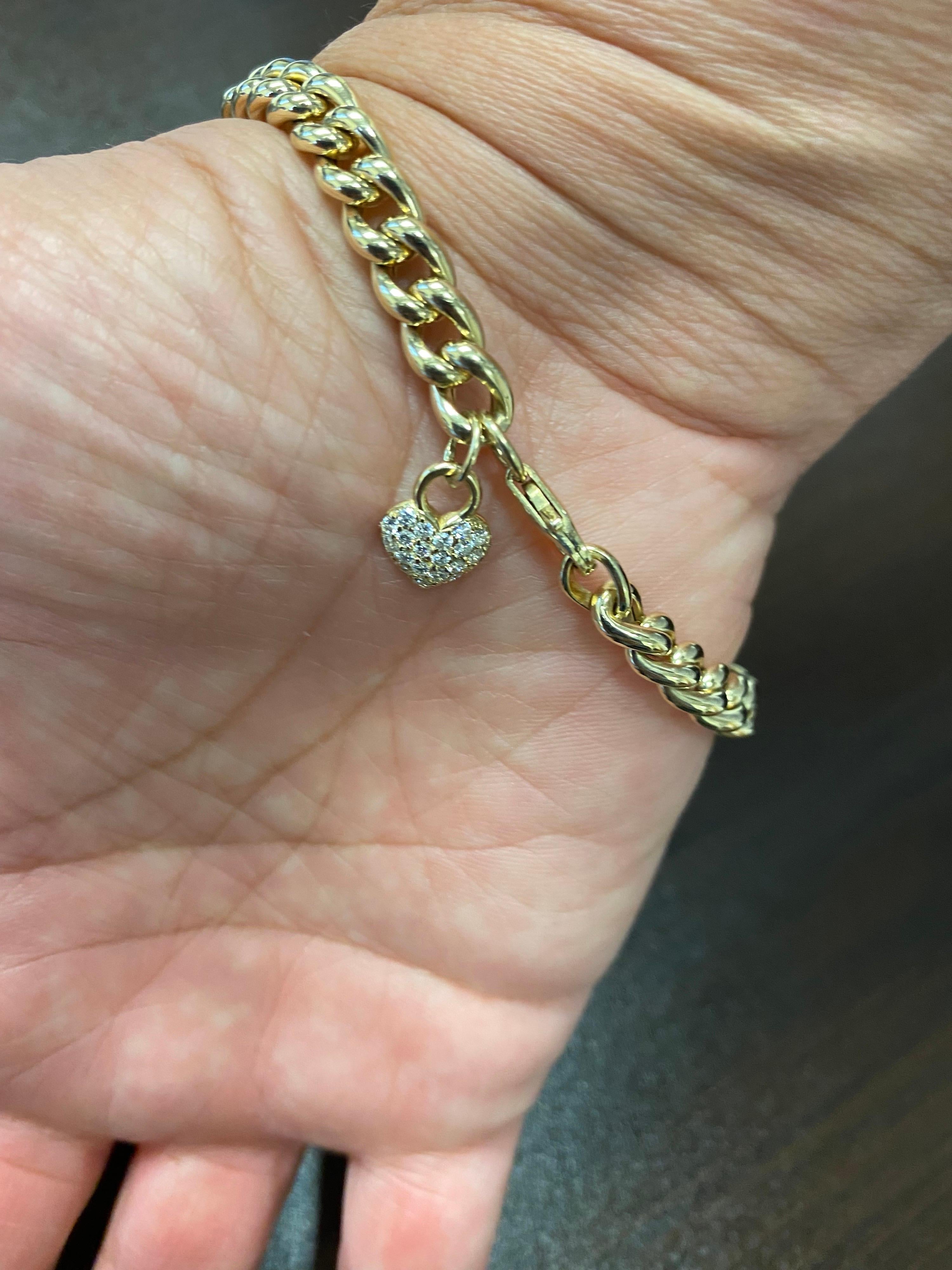 Diamond bracelet set in 18K yellow gold Cuban link. Diamonds also set on the heart clasp of the bracelet. The total carat weight of the bracelet is 1.25. The diamonds are set with 0.01 carats each stone.
The color of the stones are G, the clarity is