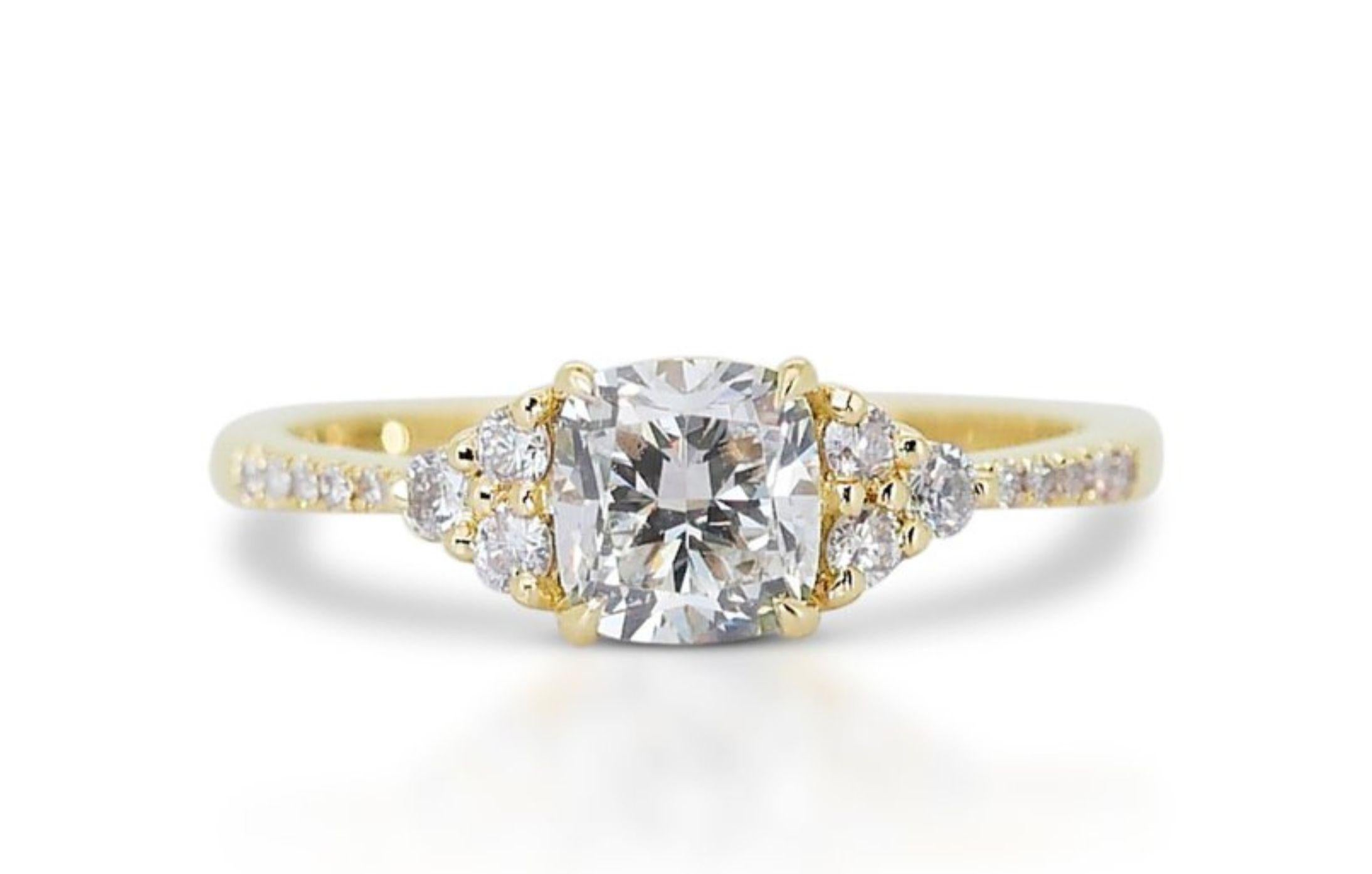 Prepare to be captivated by a ring that embodies the radiant warmth of a sun-kissed summer meadow. This breathtaking creation features a dazzling 1.01 carat cushion-cut diamond, its G color radiating pure, luminous beauty with a hint of golden