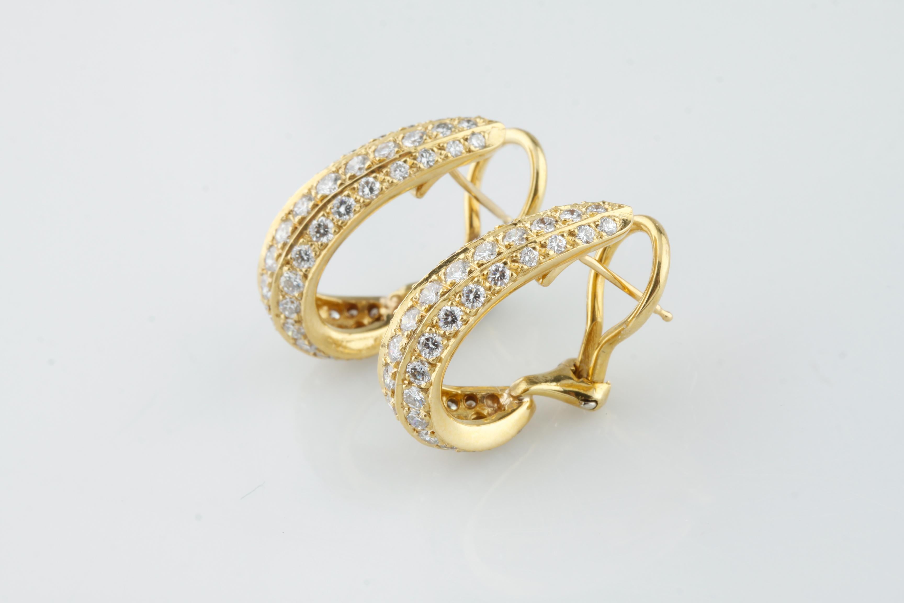 Gorgeous, Unique Gold Huggie Hoop Earrings
Feature Three Rows of Pave-Set Round Diamonds
Total # of Diamonds = 96
Total Carat Weight of Diamonds = Approximately 2.75 Ct
Average Color = F - G
Average Clarity = VS
Length of Drop = 22 mm
Width of