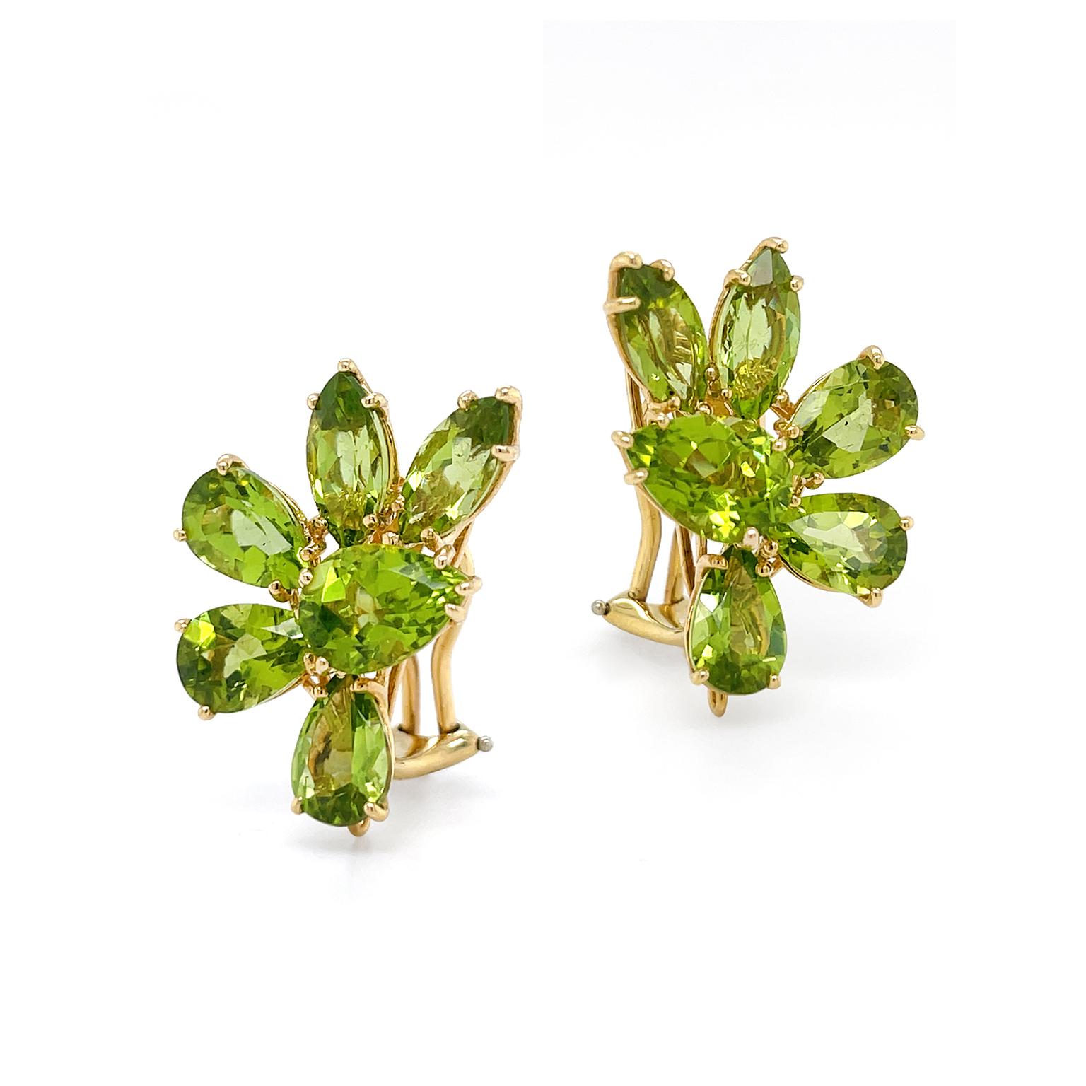 Olive-green radiance of peridot is presented in these earrings. A single pear cut of the gem is orbited halfway by illuminating two marquise and three pears. Marquise cuts accentuate both the depth and weight of the gem, while the pear cuts lift
