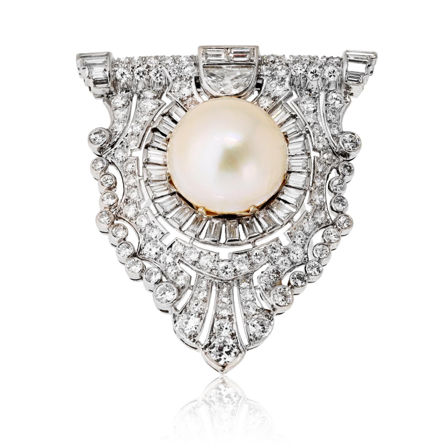Réalisée à l'époque de l'Art déco, cette élégante broche à clip en platine témoigne du glamour intemporel des années 1920 et 1930. En son centre se trouve une perle lumineuse de 10 mm, encadrée par un arrangement saisissant de diamants ronds de