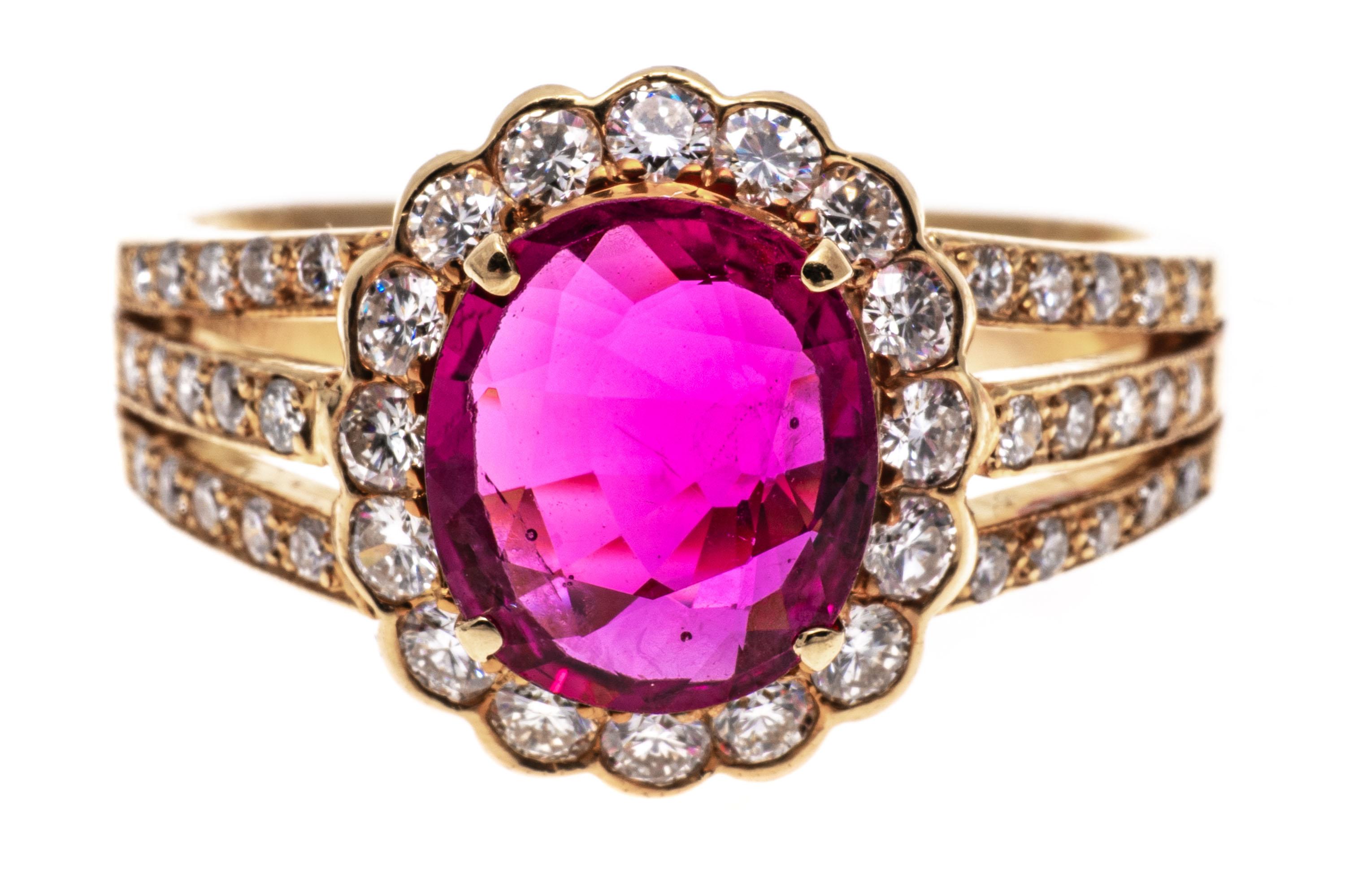 18k Yellow Gold Pink Sapphire And Diamond Cluster Ring
This striking ring is a cluster style, set with a faceted oval shape, medium pink color lab created pink sapphire center, prong set. Surrounding the stone is a halo of round brilliant cut