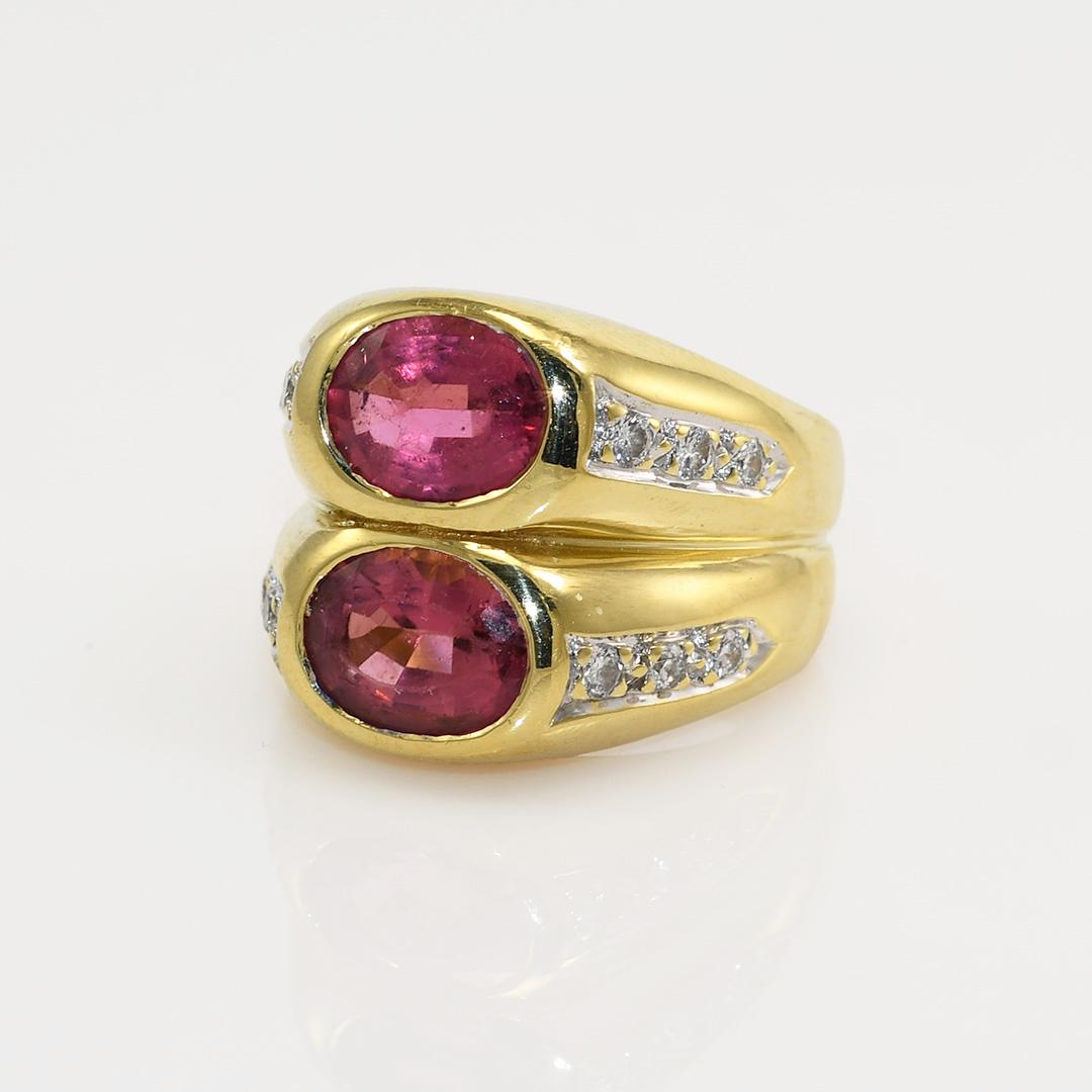 18K Yellow Gold Pink Tourmaline & Diamond Ring, 27.9g
Pink tourmaline and diamond ring with 18k yellow gold setting.

The ring tests 18k and weighs 27.6 grams gross weight.

The tourmalines are oval cuts, 2.85 carat and a 2.50 carat.

There are some