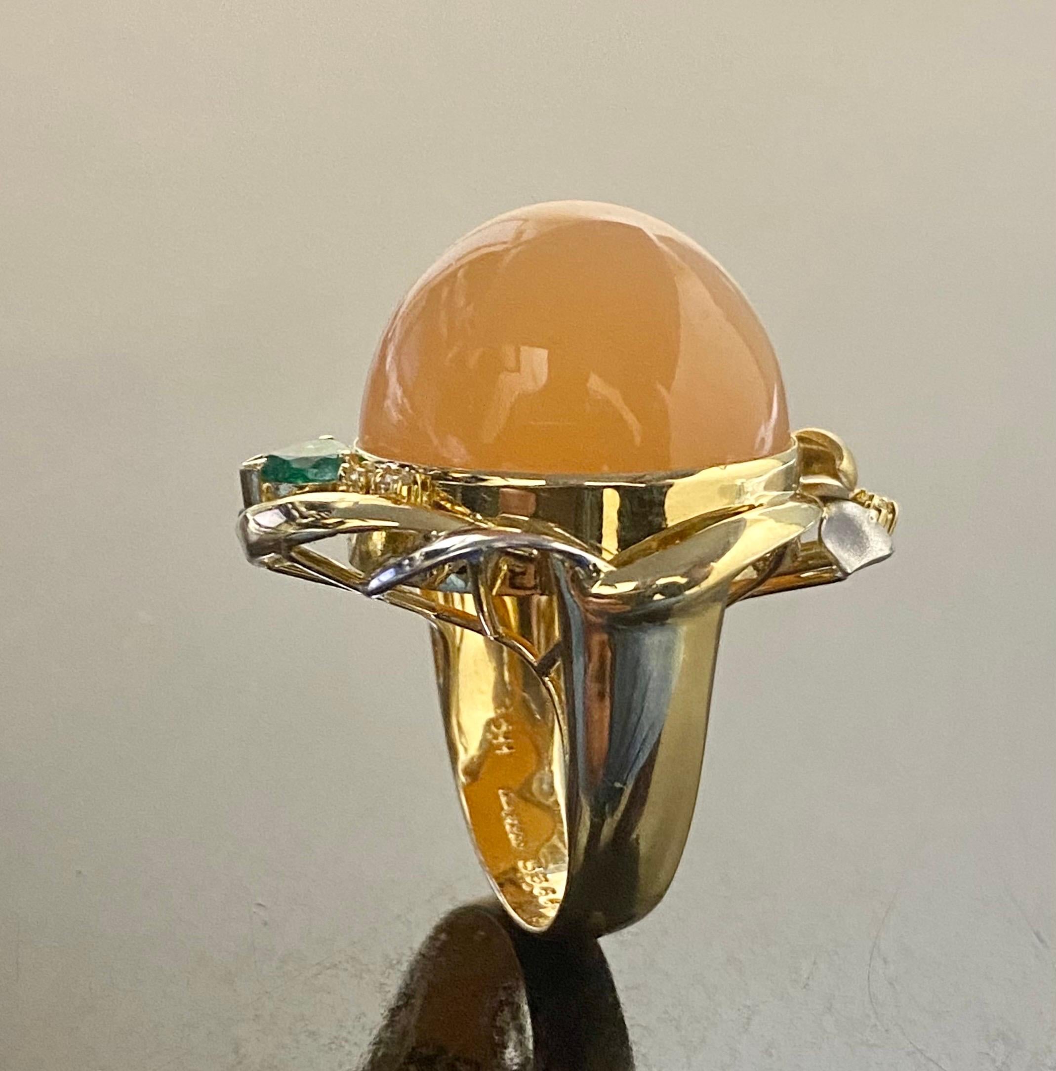 DeKara Design Collection 

Metal- 18K Yellow Gold, .750.  90% Platinum, 10% Iridium.

Stones- Genuine Cabochon Cat's Eye Pink Moonstone 53.66 Carats, Heart Shape Colombian Emerald 0.43 Carats,   4 Round Diamonds G-H Color SI1 Clarity 0.11