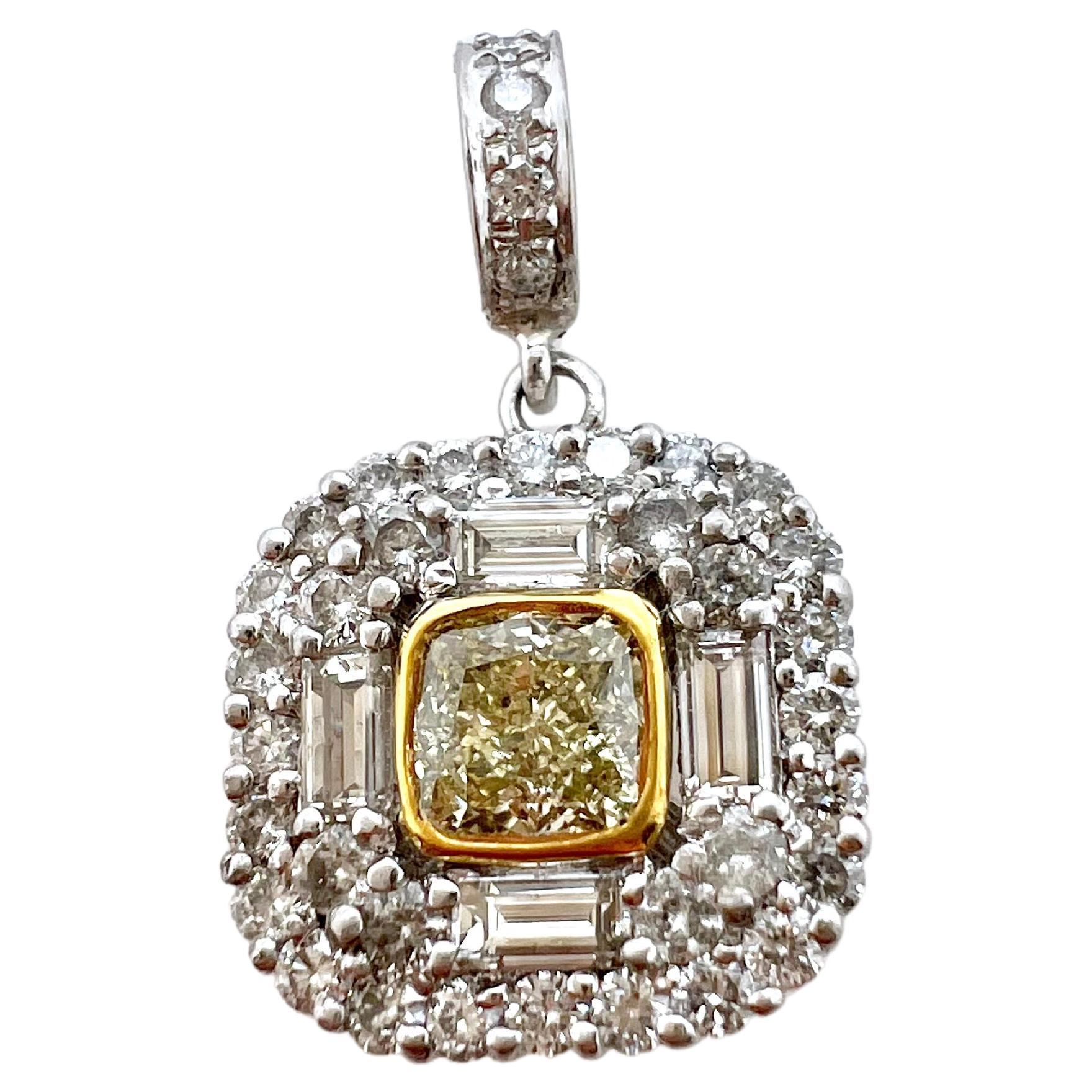 This exquisite yellow diamond in set in an 18k yellow gold bezel setting and is strategically placed within the custom platinum setting with round brilliant and baguette diamonds.  It hangs off a 18k yellow gold diamond chain with 0.22 ct of round