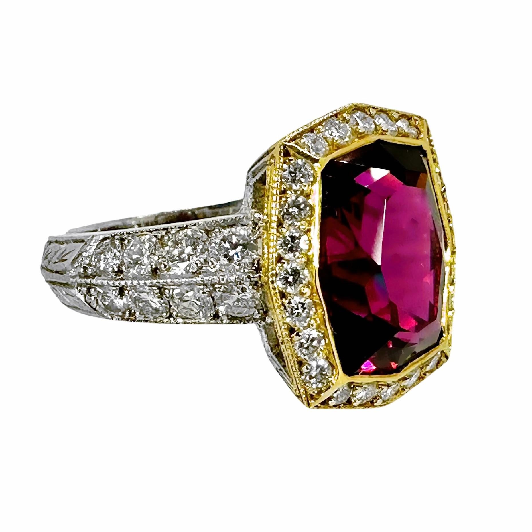 This unique ring with a vibrant rhodolite Garnet center, the color of fine red wine, is a very skilled melding of 18k yellow gold and platinum. The modified cushion cut center garnet dominates this jewel which was, no doubt, crafted by an absolute