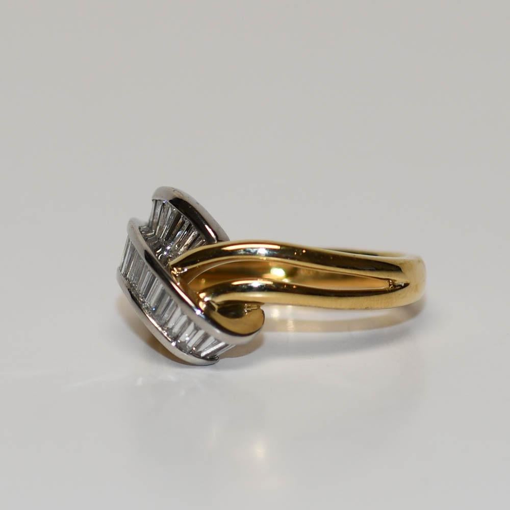 Ladies diamond band in 18k yellow gold and platinum setting.
Stamped 18k, Irid, Plat, 1.07 and weighs 7.9 grams.
The main ring shank is 18k and the top of the ring is platinum & iridium.
The diamonds are baguette cuts, 1.07 total carats, F to G