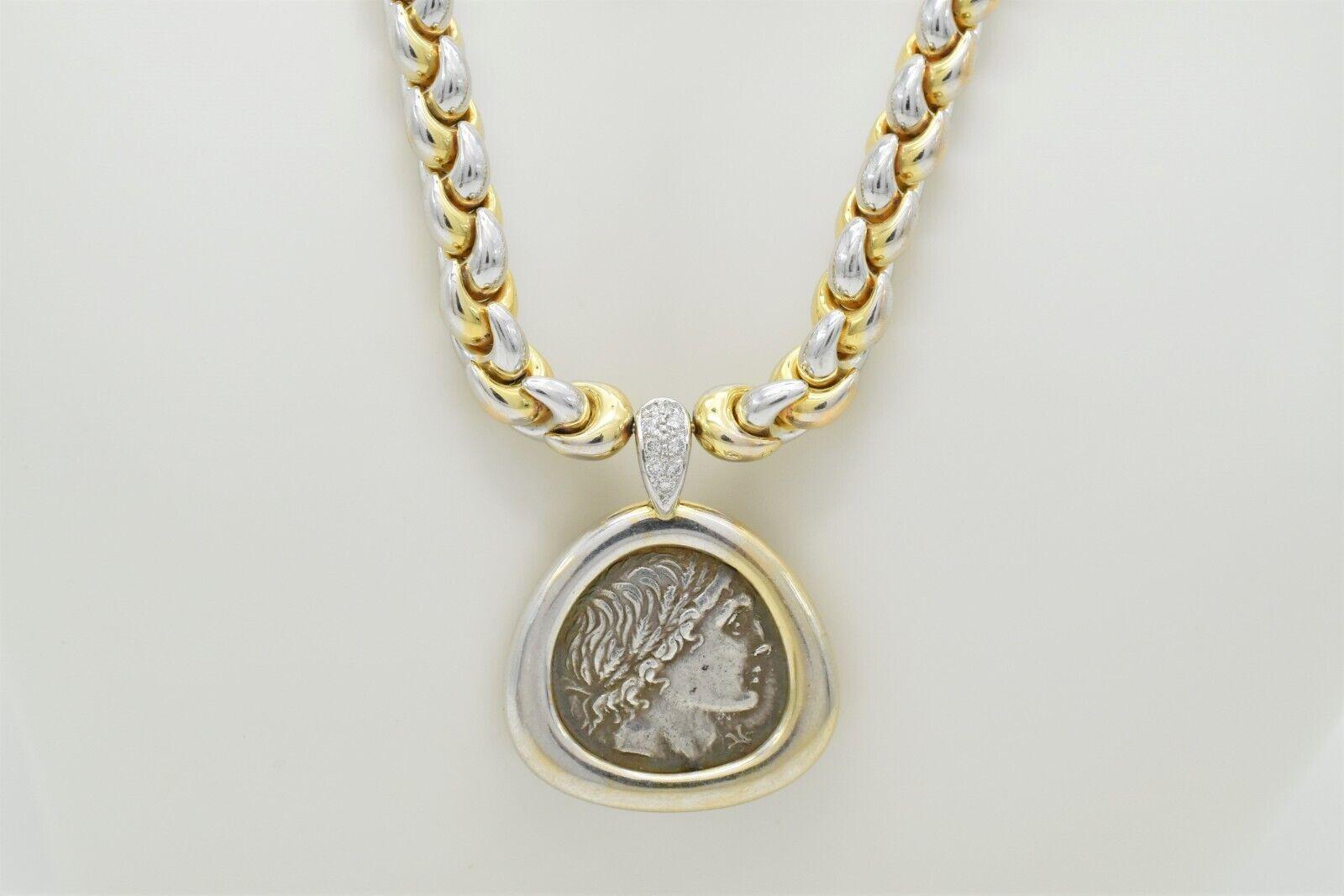 This beautiful necklace with a unique design and combination of 18k yellow gold and platinum features a stationary pendant. The bail has 9 small prong set diamonds accenting the accent roman bezel set coin, Denarius of L. Memmius, Rome, - Moneyer of